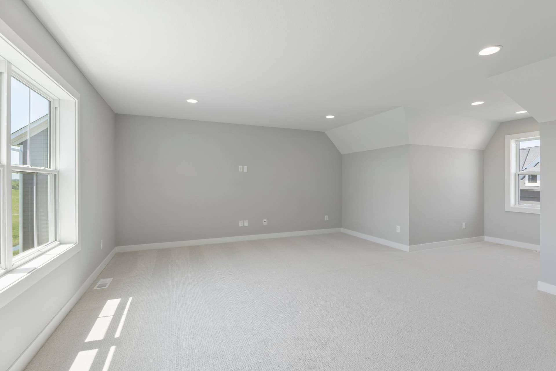 10409 Blackmoor Road, Woodbury, MN 55129 Spacious bonus room above three car garage features windows on both the front and back for maximum light (photo of actual listing).