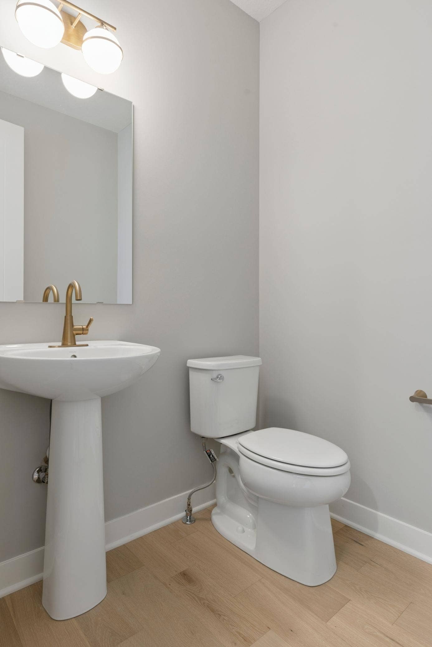 10409 Blackmoor Road, Woodbury, MN 55129 Main floor powder room with graceful pedestal sink (photo of actual listing).