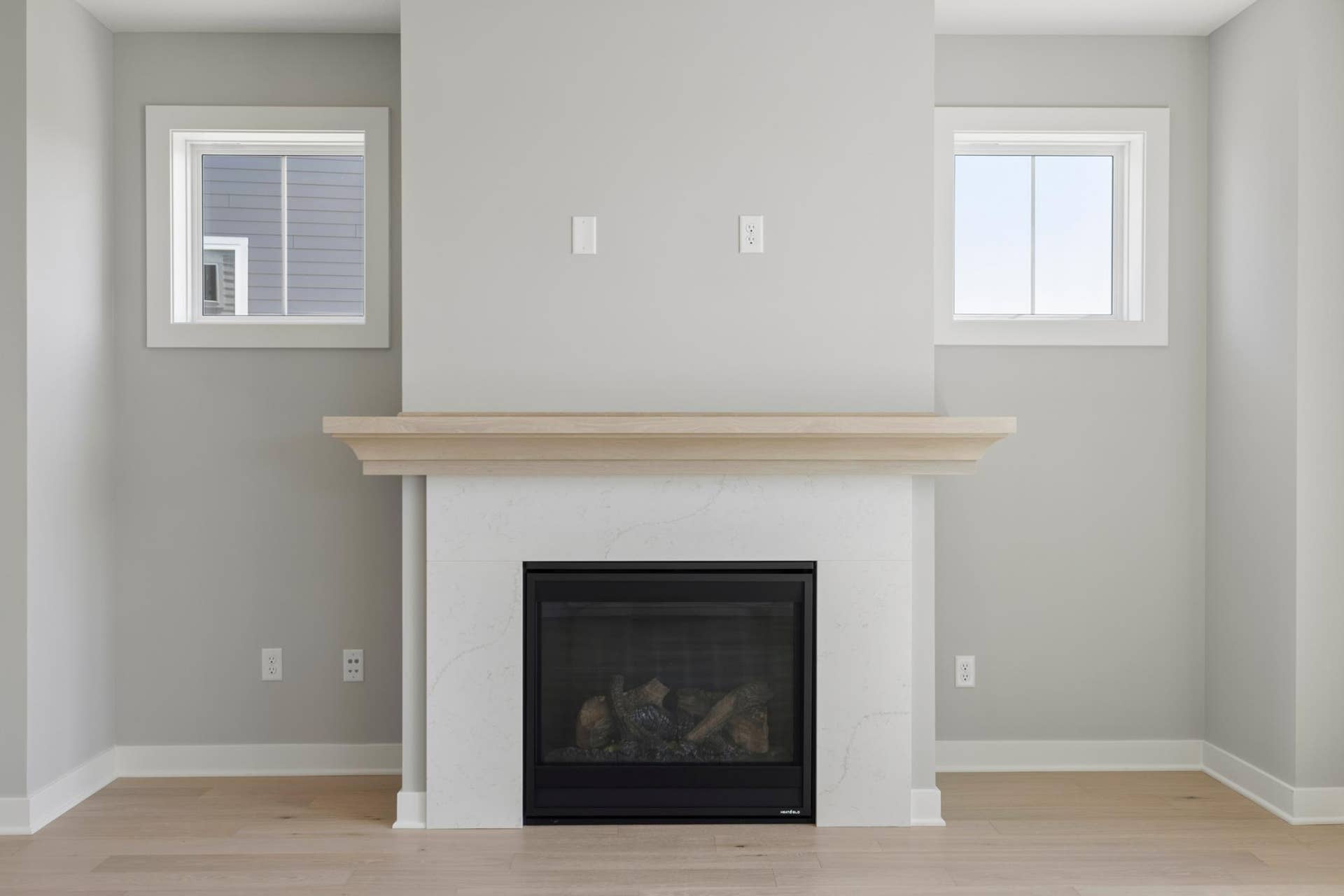 10409 Blackmoor Road, Woodbury, MN 55129 Gas fireplace includes quartz surround and white oak mantel plus tech tube and electrical for future hanging television (photo of actual listing).