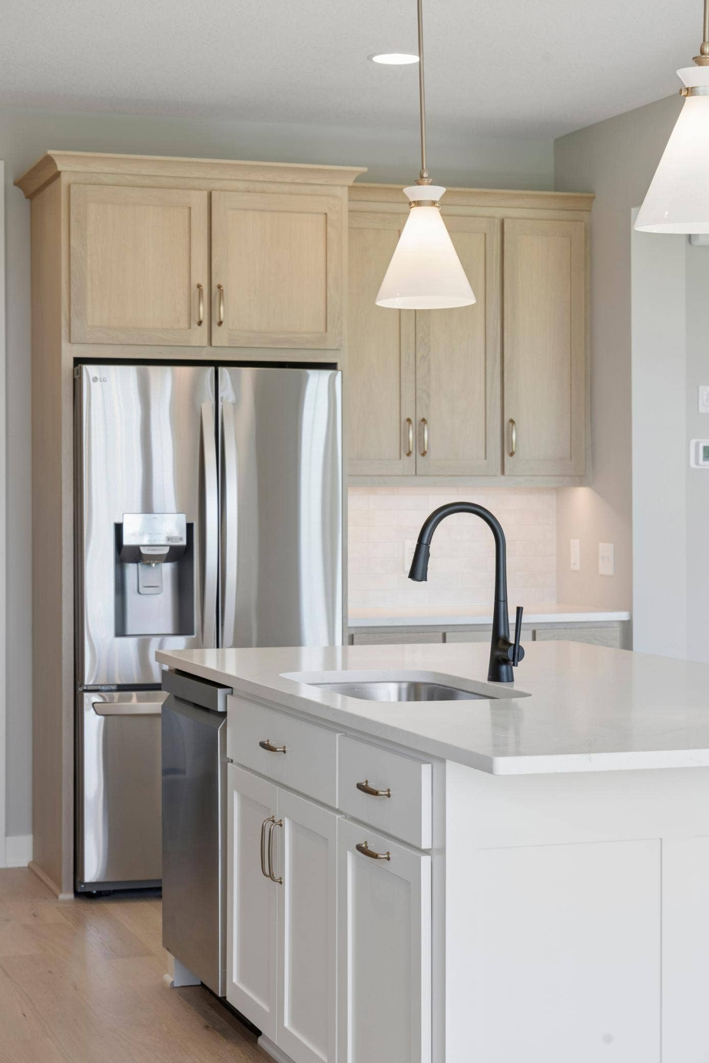 10409 Blackmoor Road, Woodbury, MN 55129 Large kitchen sink and french door refrigerator plus undercabinet lighting (photo of actual listing).