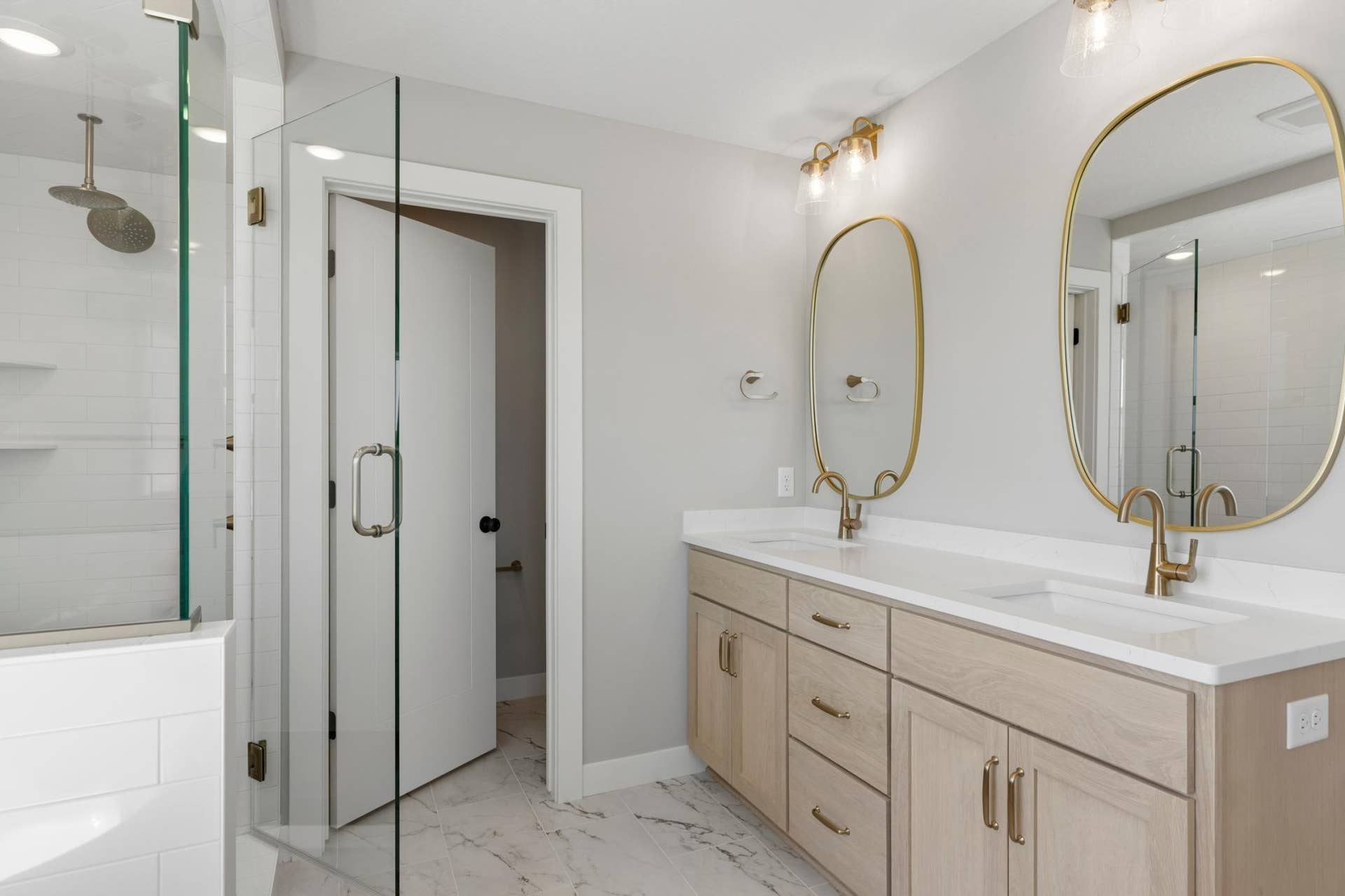 10409 Blackmoor Road, Woodbury, MN 55129 Double sink vanity with quartz countertops, stunning framed mirrors and oak cabinetry (photo of actual listing).