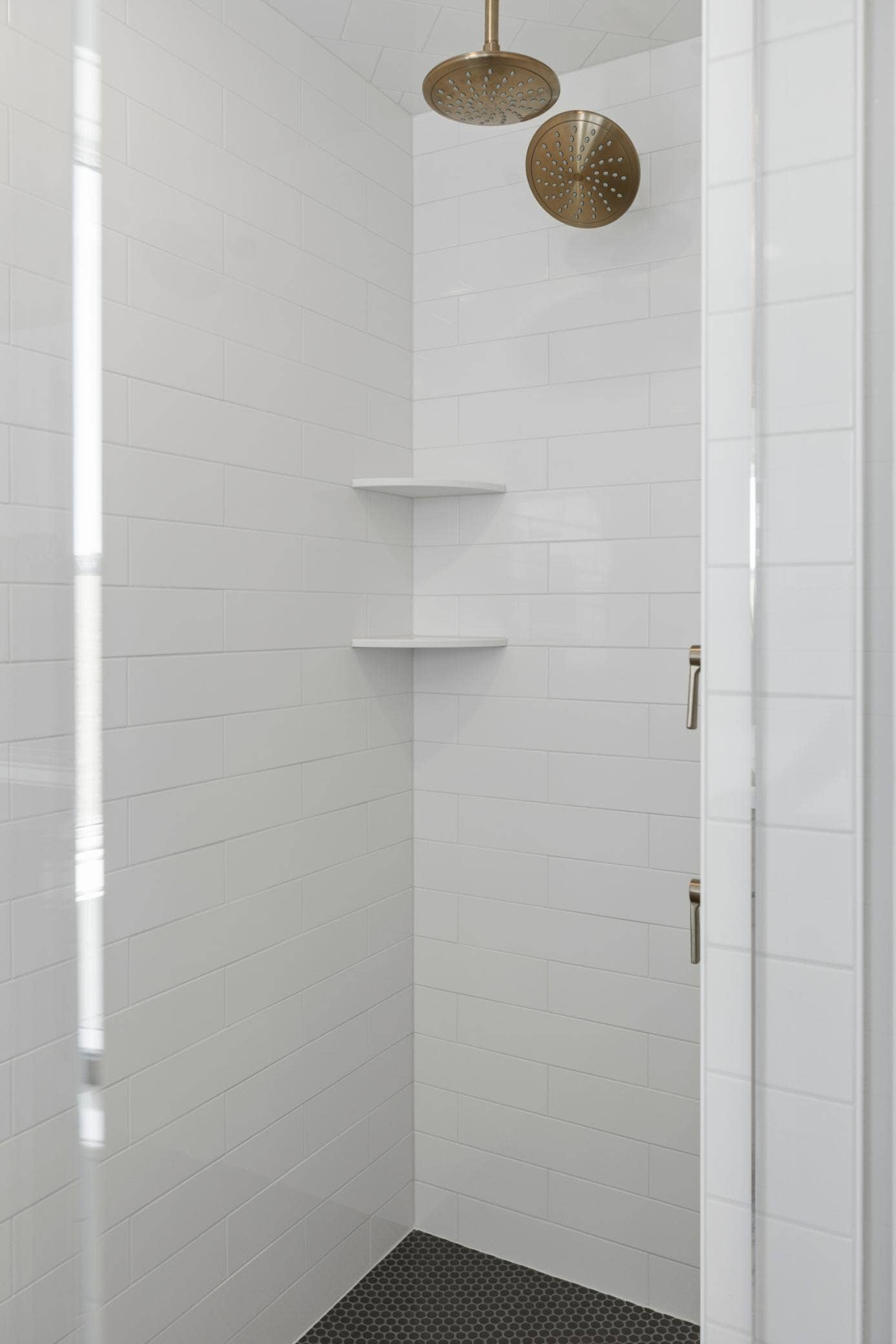 10409 Blackmoor Road, Woodbury, MN 55129 Large shower in primary bath with two shower heads, ceramic tile walls, floor & ceiling plus frameless shower door (photo of actual listing).