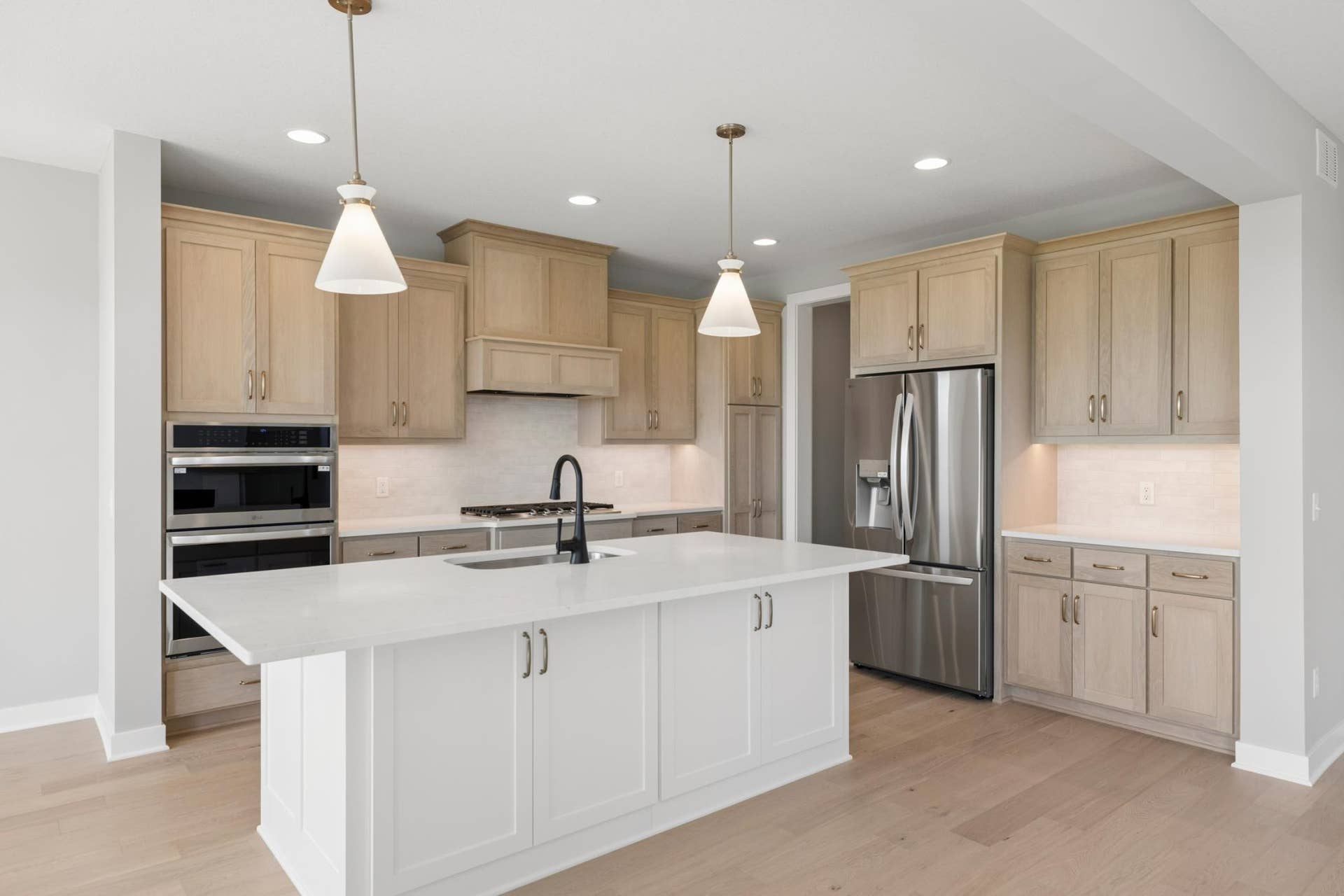 10409 Blackmoor Road, Woodbury, MN 55129 Kitchen features large center island with cabinets on both front & back of island (photo of actual listing).
