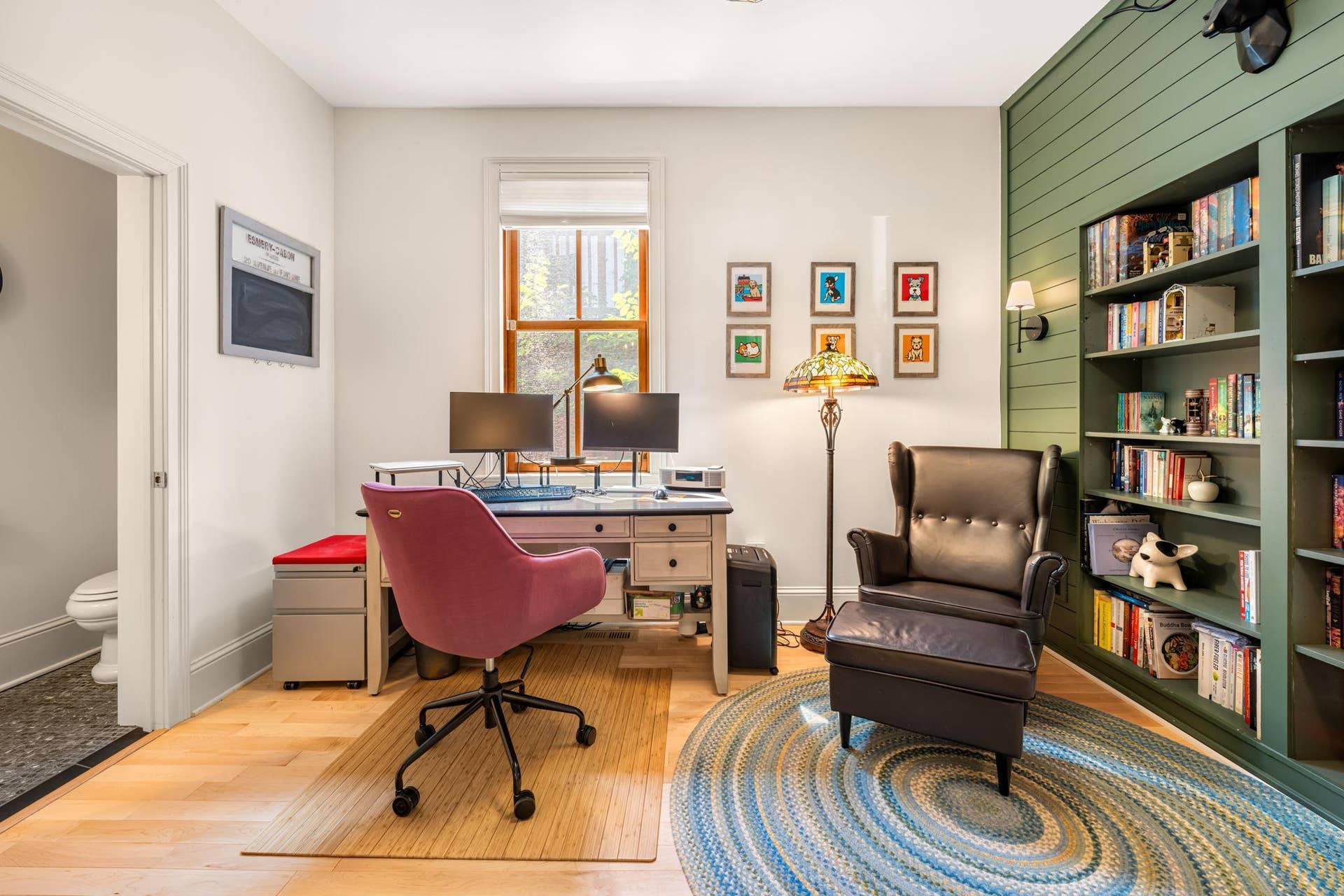 French doors lead into a freshly painted main level office with built-in book shelves and a powder bath.