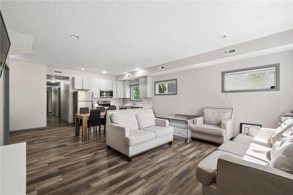 211 Belvidere Street E, 104, Saint Paul, MN 55107 211-Belvidere-Street-E-Saint-Paul-MN-55107-08-Living-Room-and-Kitchen-AI-Edited.jpg