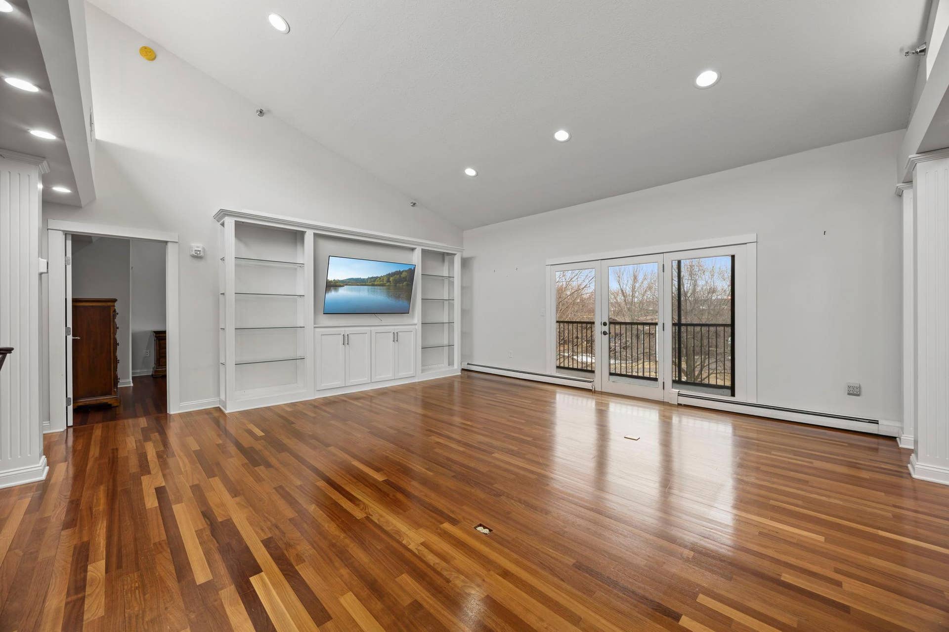 3150 Glen Oaks Avenue, #311A, White Bear Lake, MN 55110 The living room features hardwood floors, a full wall of built ins and is open to the kitchen, dining room and screened in porch.