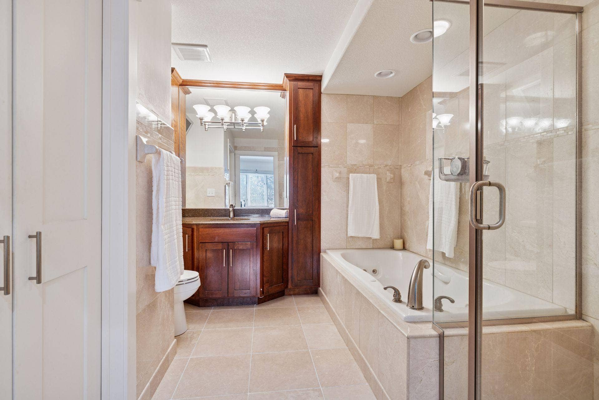 3150 Glen Oaks Avenue, #311A, White Bear Lake, MN 55110 The private primary bathroom features both a soaking tub and walk-in shower and tile floors.