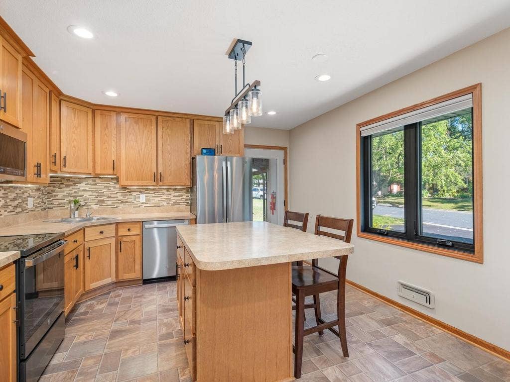 13008 Lakeview Drive Drive, Burnsville, MN 55337 A large window brings natural light into the kitchen and island seating area.