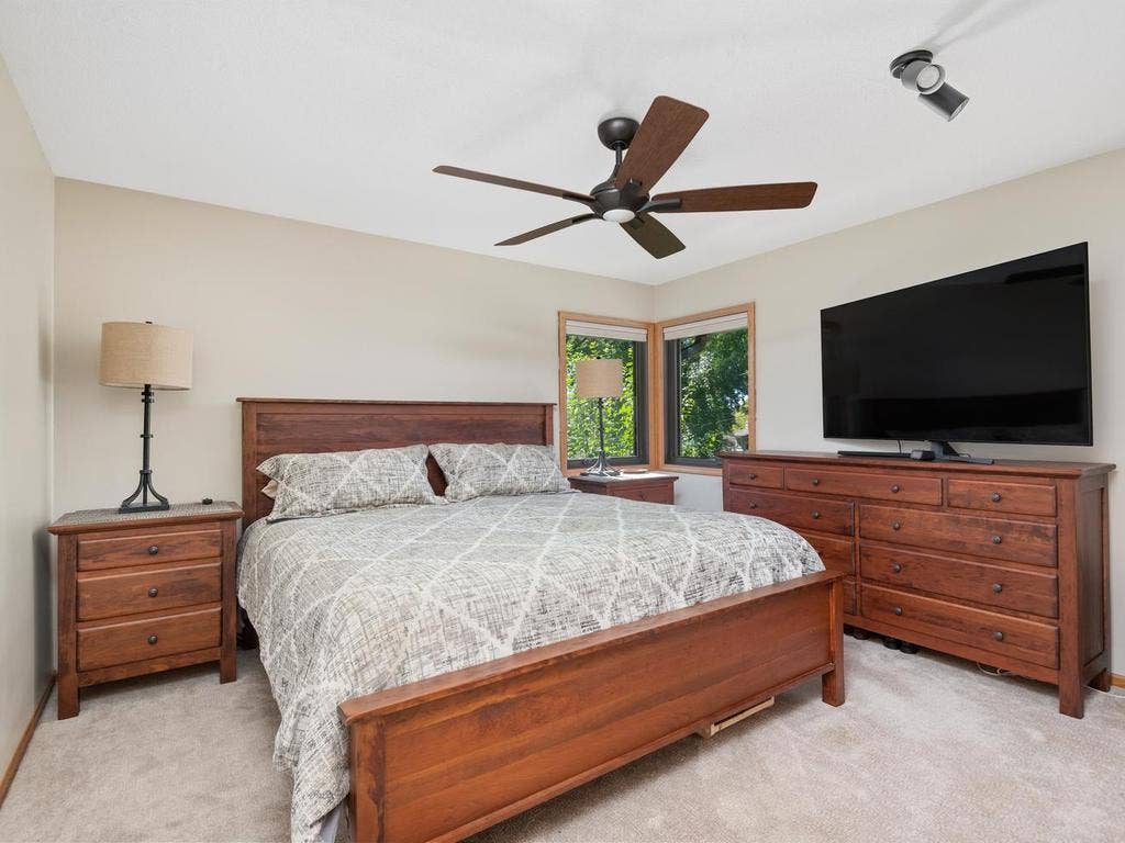 13008 Lakeview Drive Drive, Burnsville, MN 55337 Main-level bedroom with corner windows and a ceiling fan.