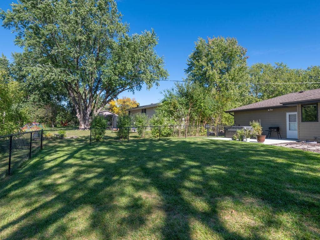 13008 Lakeview Drive Drive, Burnsville, MN 55337 The fenced backyard offers a large lawn and mature trees.