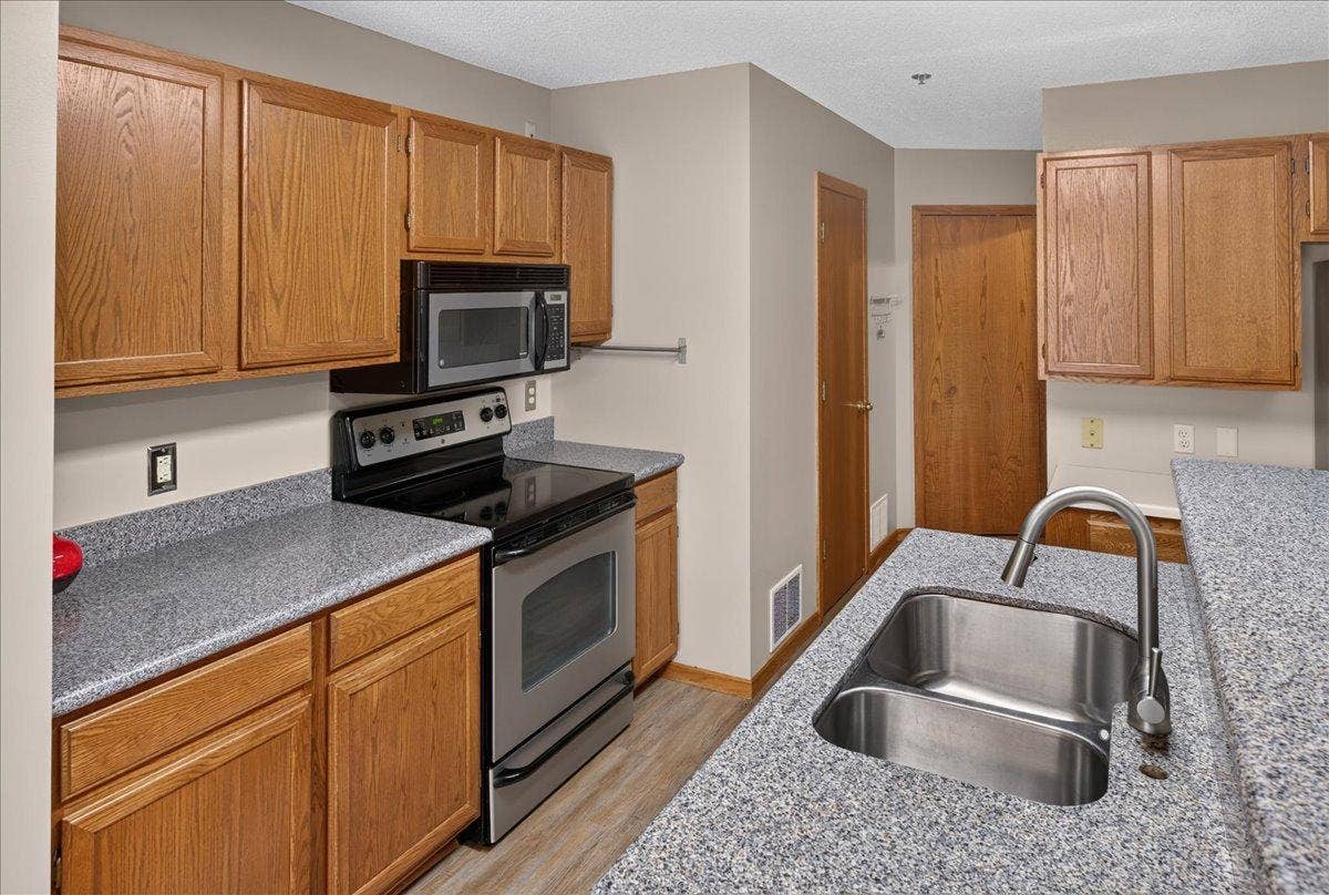 2583 Lockwood Drive, Mendota Heights, MN 55120 Kitchen offers ample cabinetry, updated countertops, and stainless-steel appliances.