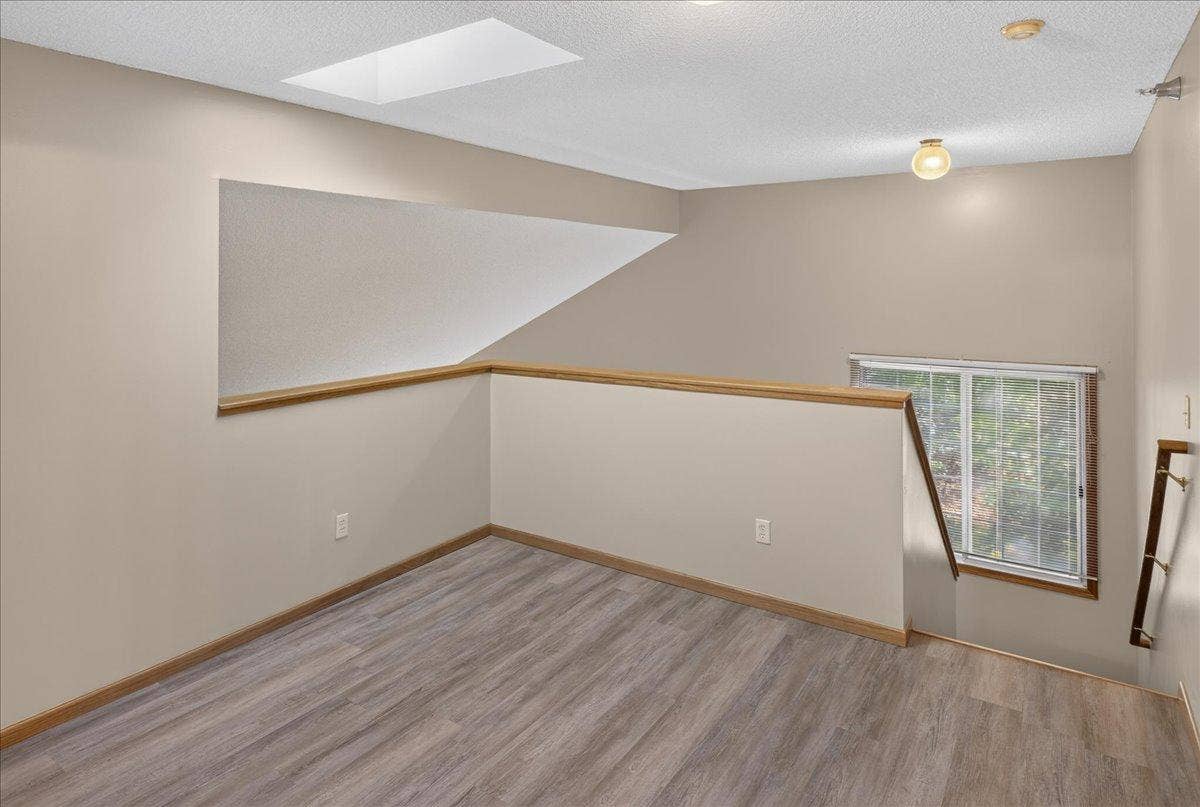 2583 Lockwood Drive, Mendota Heights, MN 55120 Versatile upper-level loft with new LVP flooring and abundant natural light.