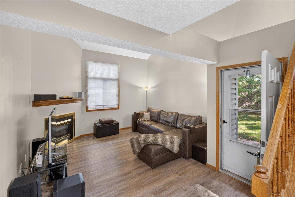 2583 Lockwood Drive, Mendota Heights, MN 55120 Spacious living room with new LVP flooring, fresh neutral paint and cozy fireplace.
