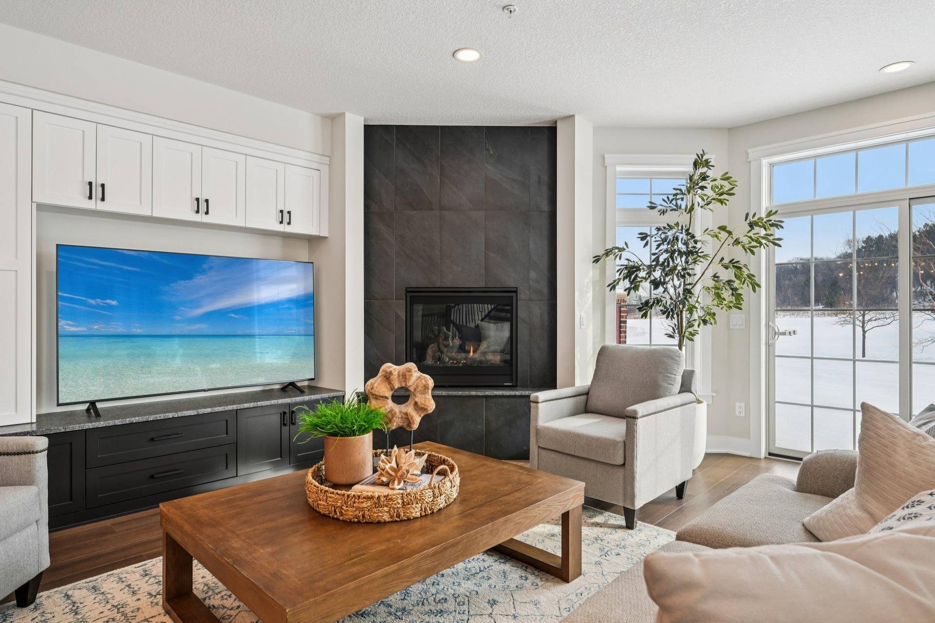 Stylish fireplace with custom built-in cabinetry creates a focal point while offering functional storage and media space.