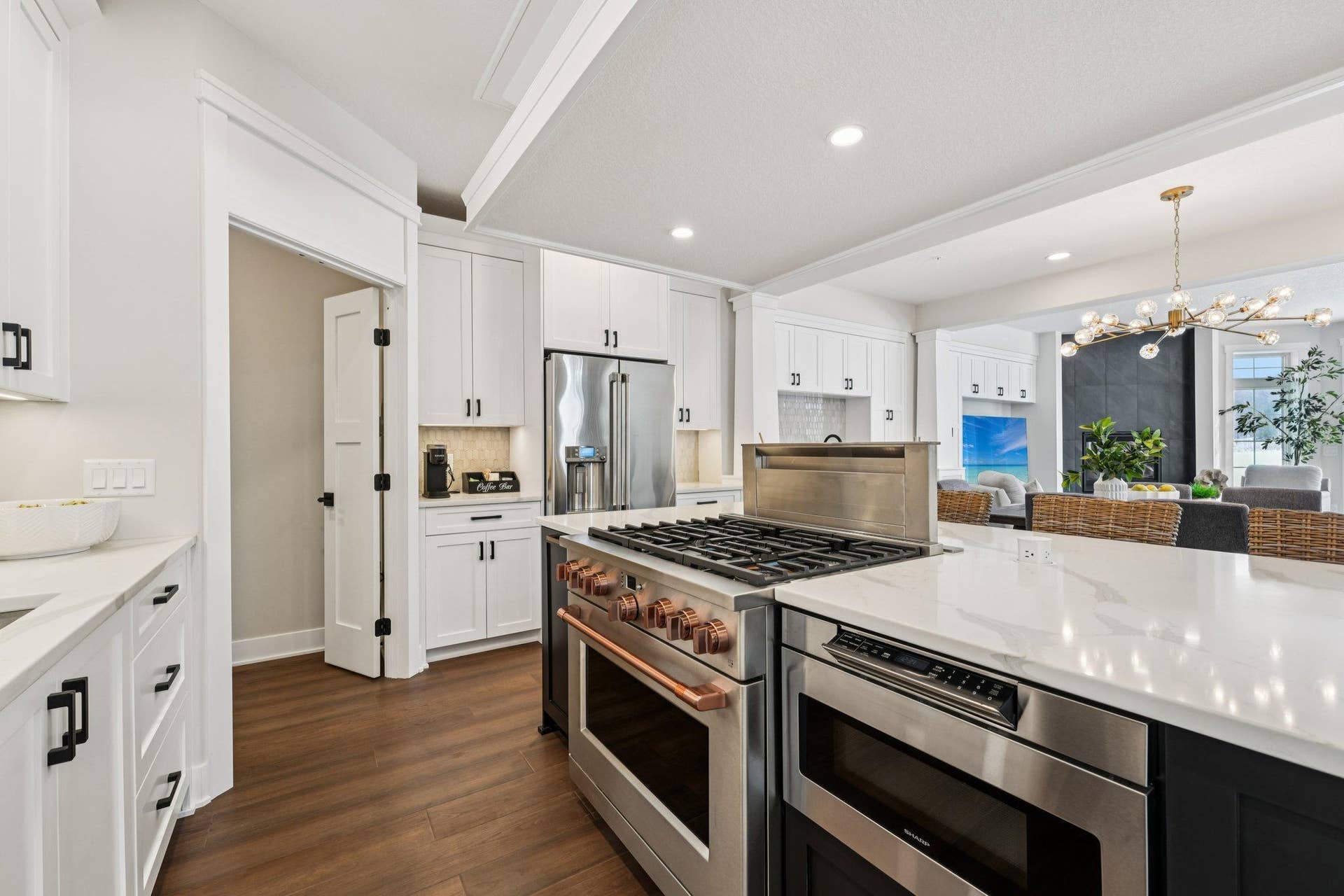 Oversized island anchors the kitchen, offering prep space, storage, and a natural gathering point for entertaining.