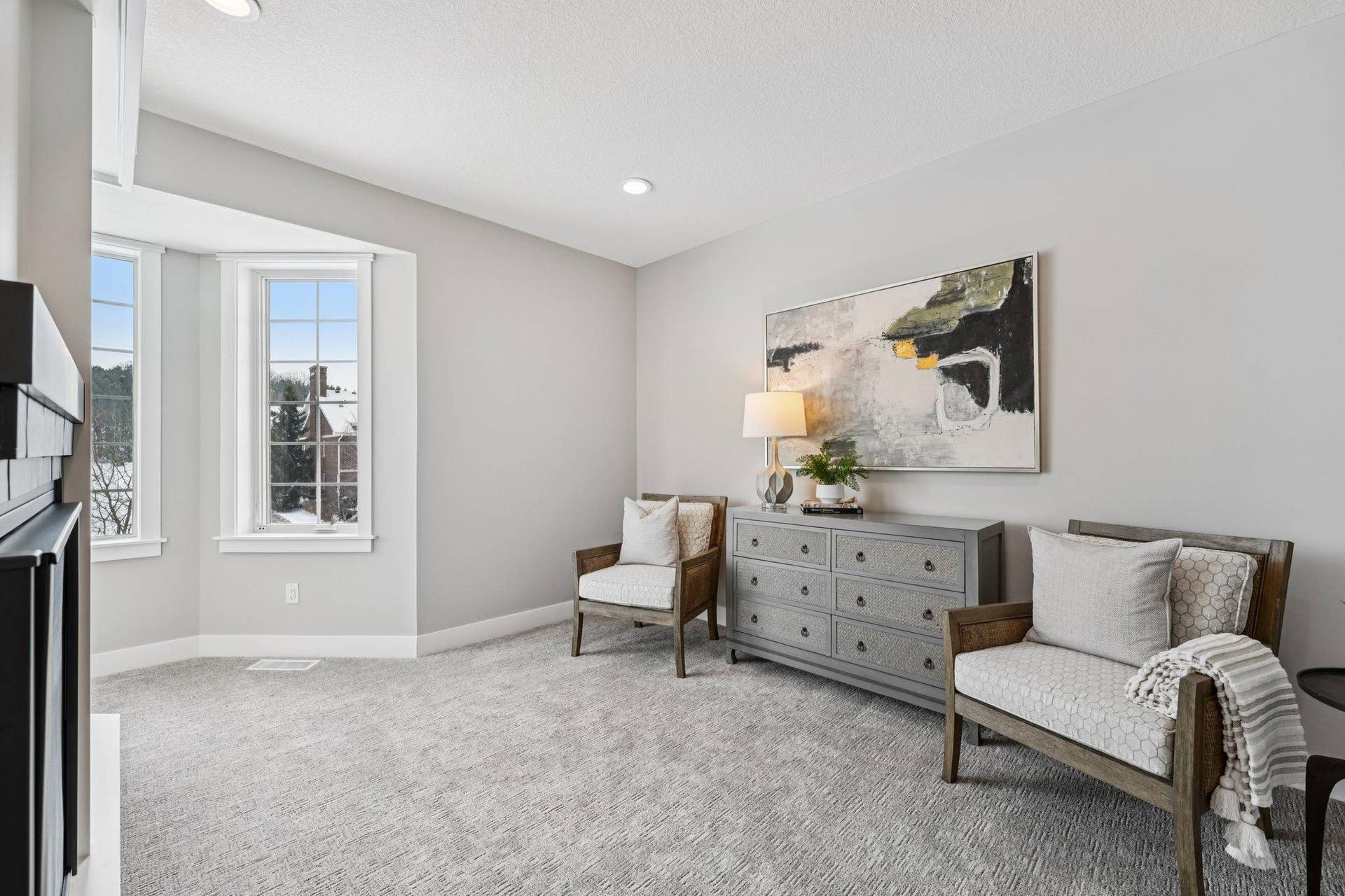 Additional view of the primary bedroom highlighting the generous layout, abundant natural light, and flexible furniture placement options.