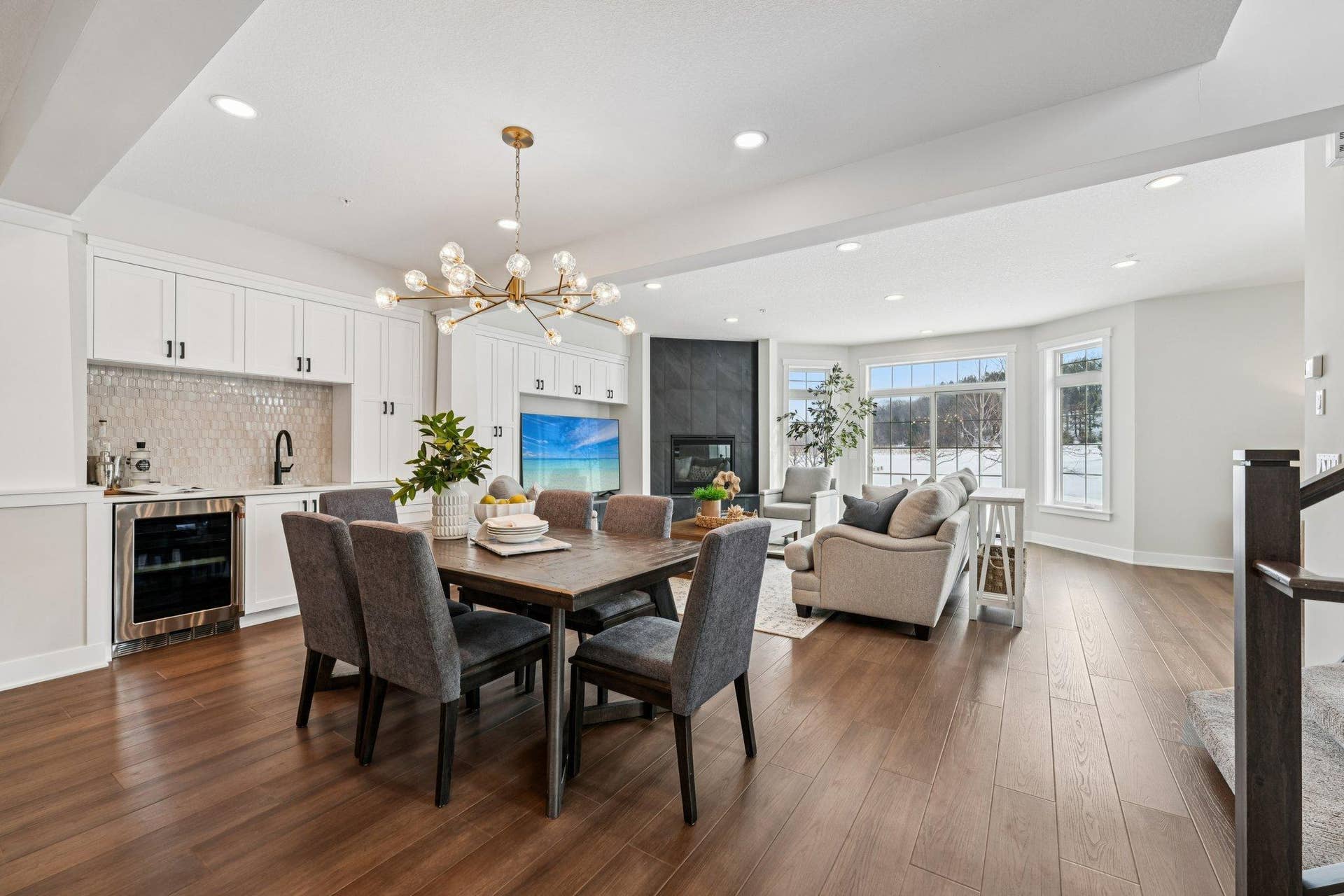 Open dining area with designer chandelier and hardwood floors, flowing seamlessly into the living spaceideal for hosting and everyday comfort.