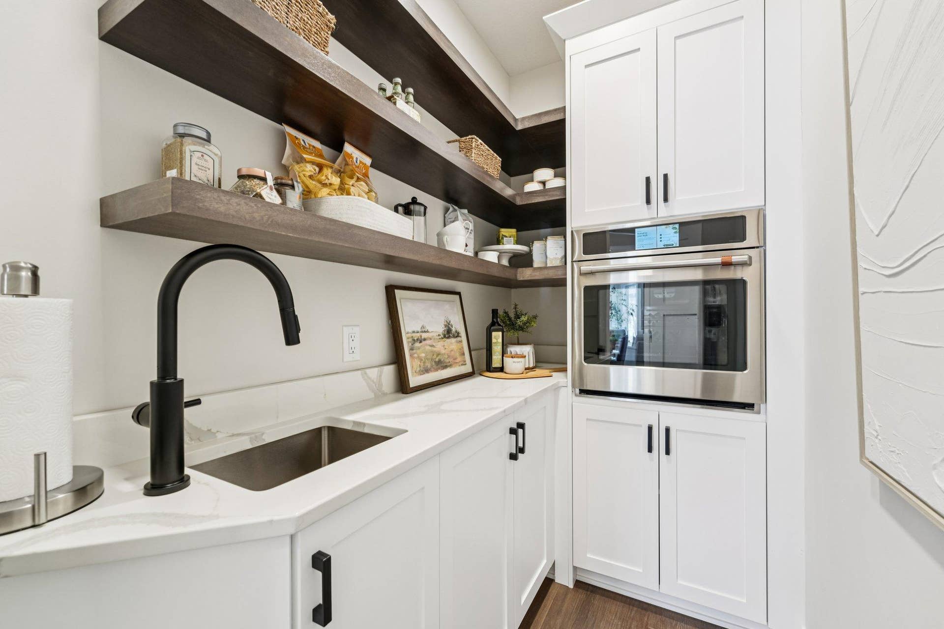 Convenient butlers pantry or beverage station with additional cabinetry, counter space, and built-in storageperfect for entertaining.