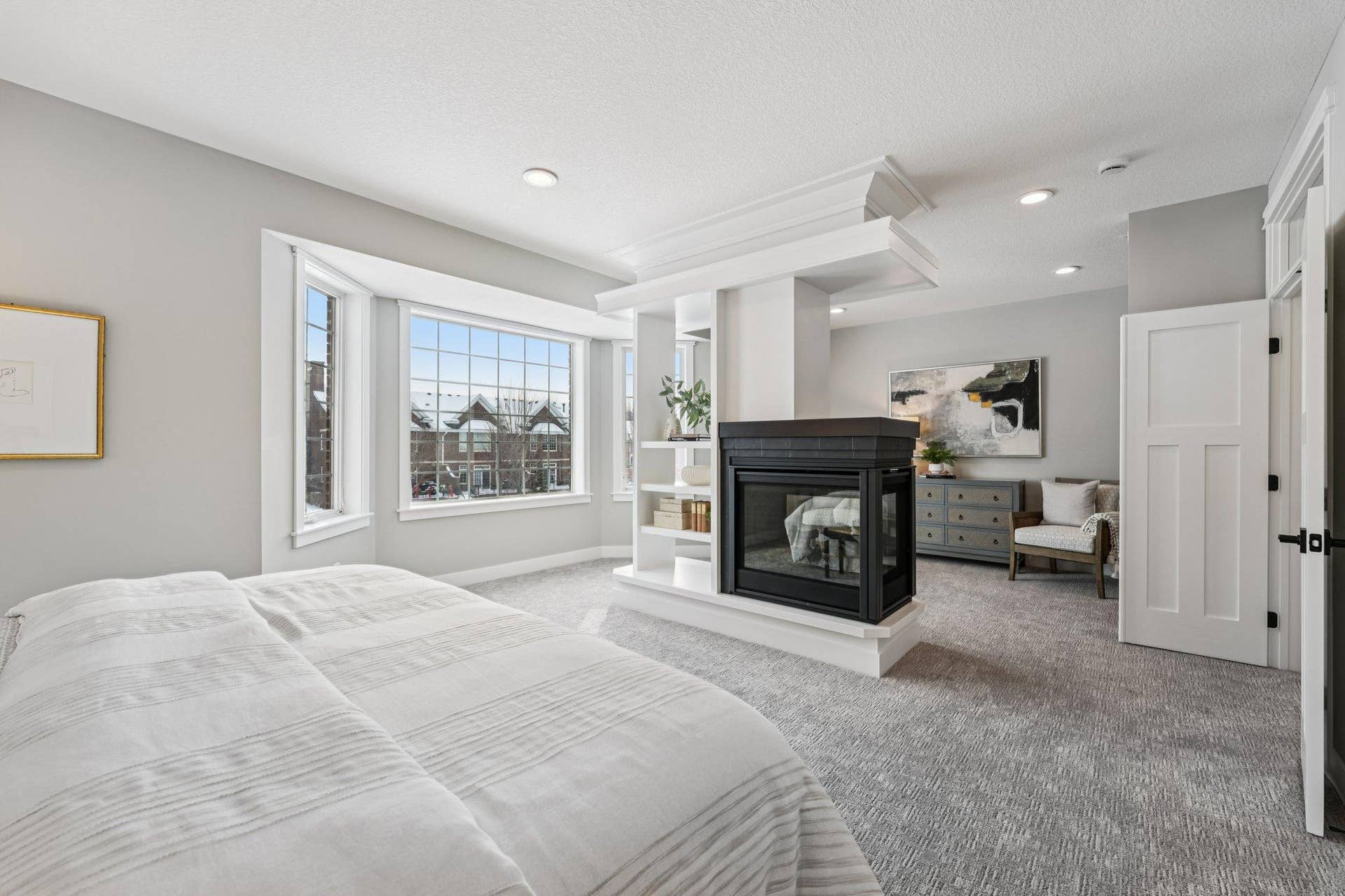 Inviting sitting area within the primary suite, separated by the fireplaceperfect for relaxing, reading, or creating a private retreat.