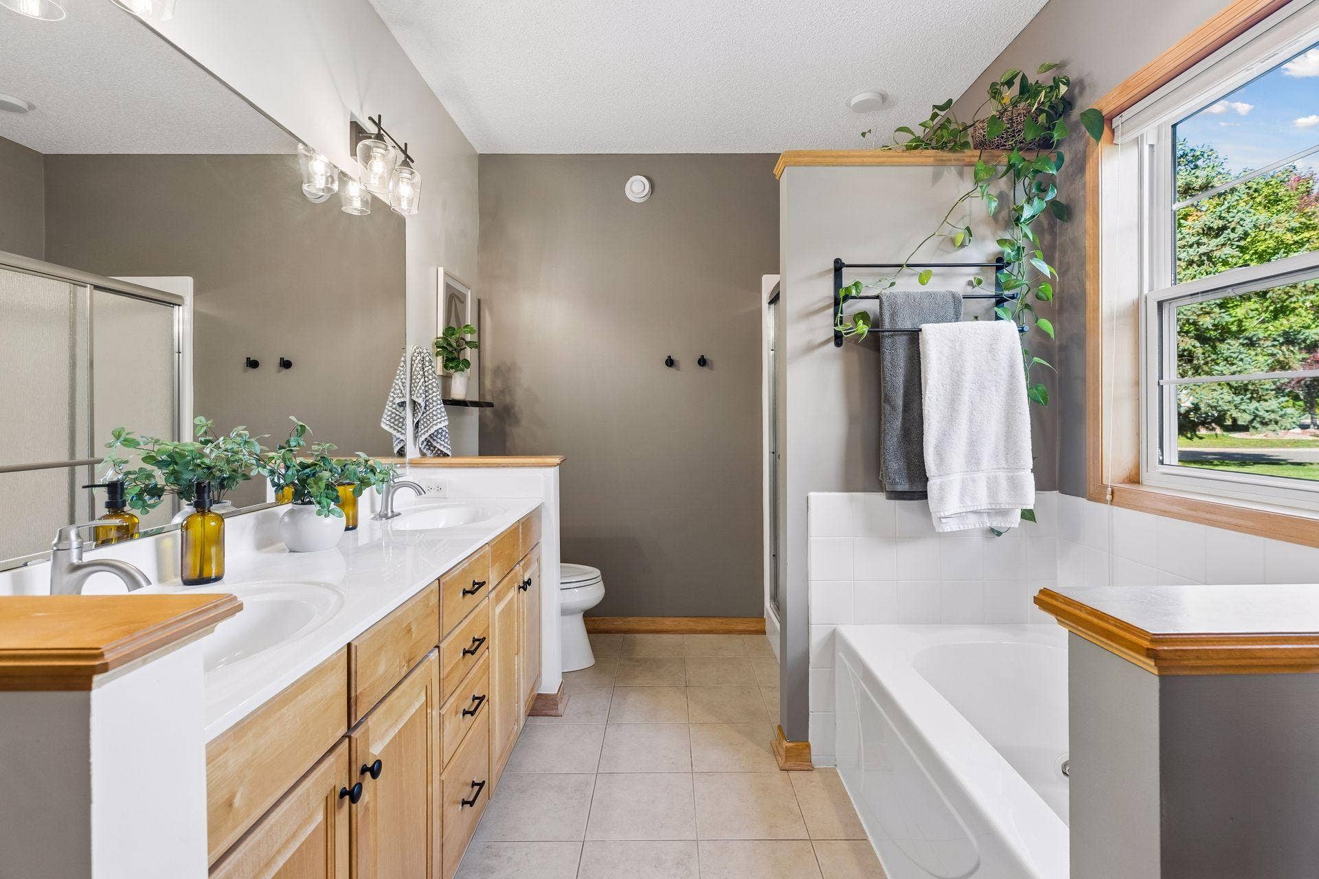 10571 Mississippi Circle N, Brooklyn Park, MN 55443 Primary ensuite bath with double sinks and separate shower and tub.