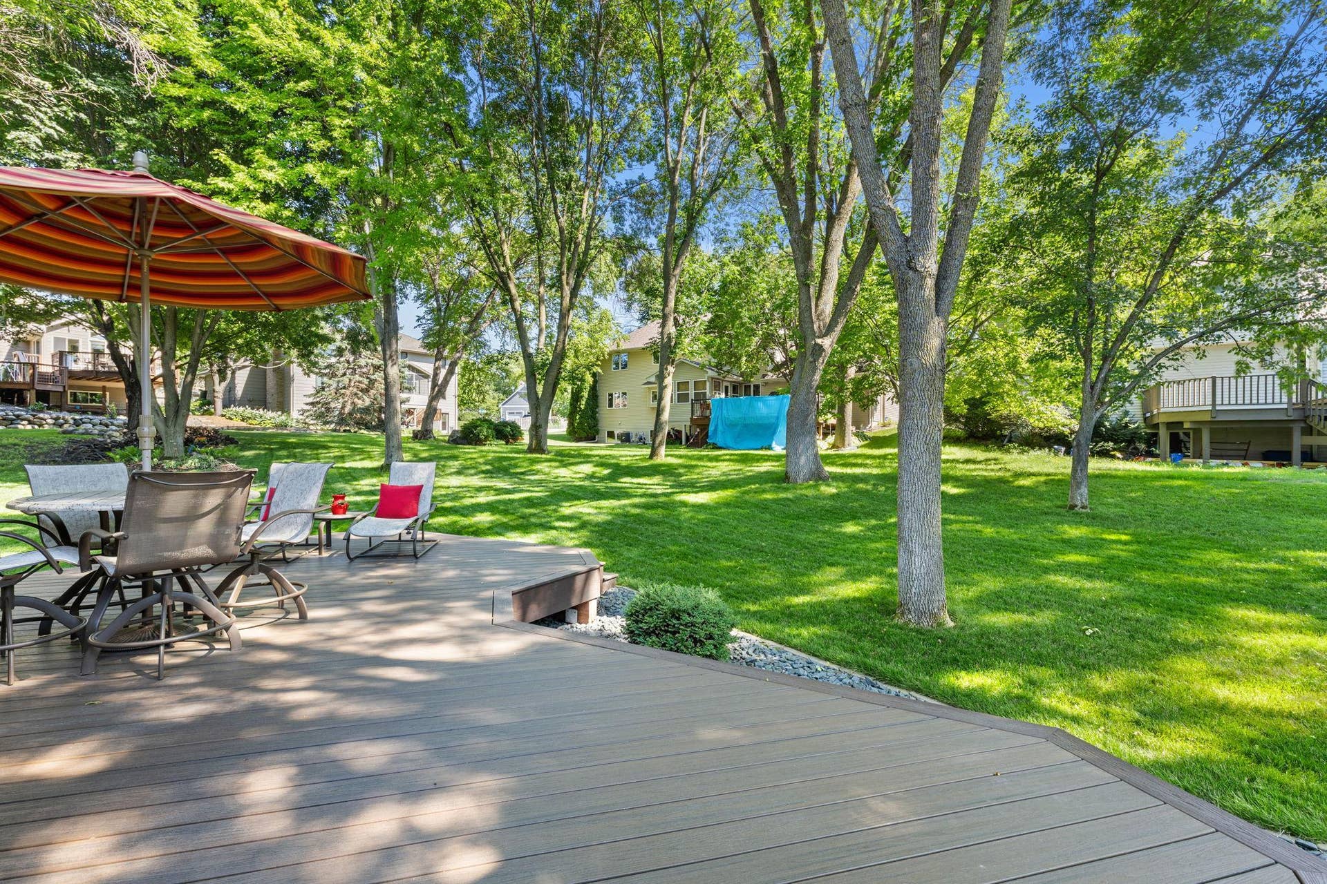 15393 Shadow Creek Road, Maple Grove, MN 55311 Outside, the backyard offers a peaceful extension of the home with a spacious Trex deck (2019), mature landscaping, and open views to surrounding greenspace without fences interrupting the scenery.