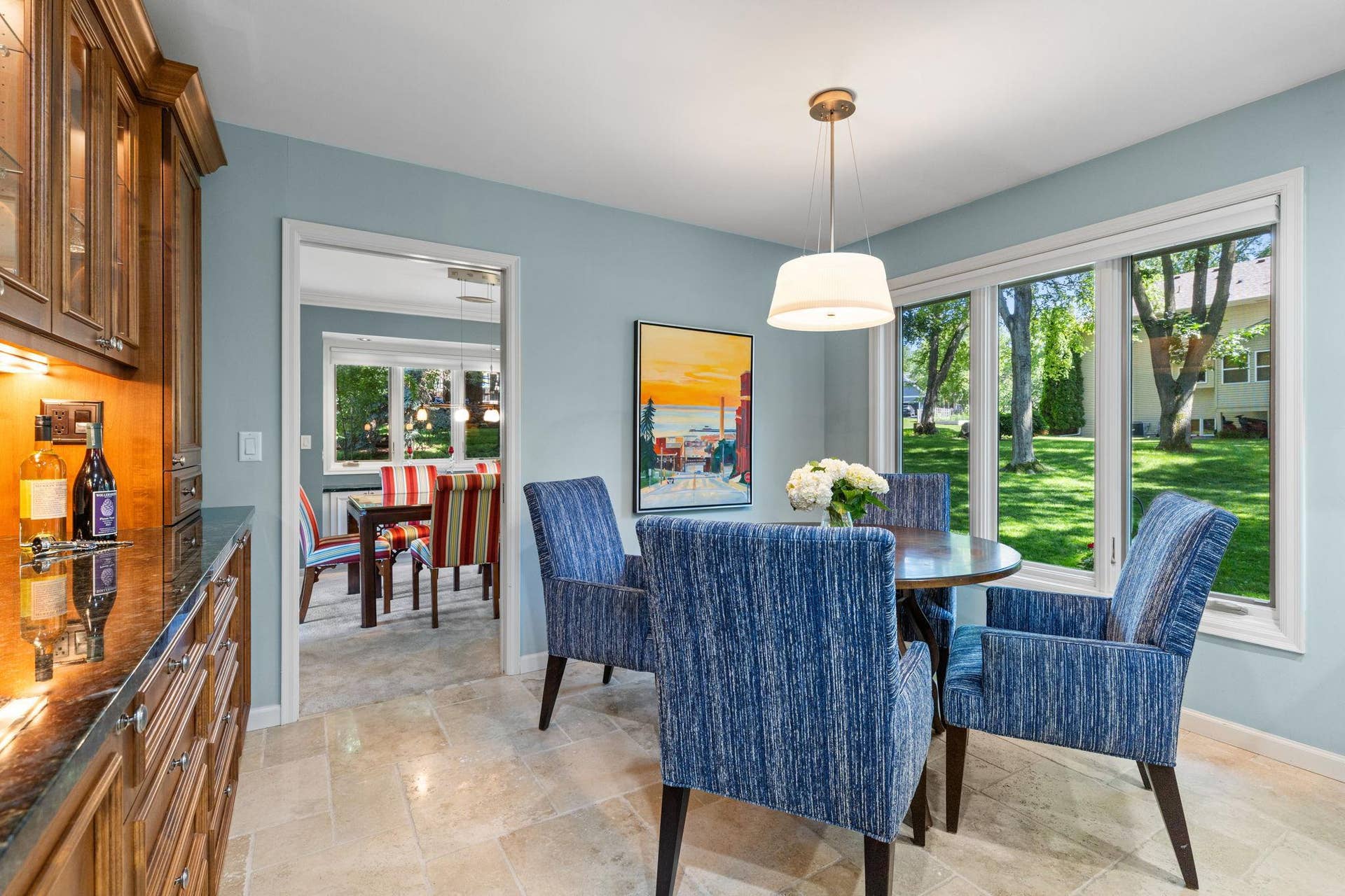 15393 Shadow Creek Road, Maple Grove, MN 55311 Just steps away, the informal dining area features a serving counter with ambient lighting and glass-front cabinetry.