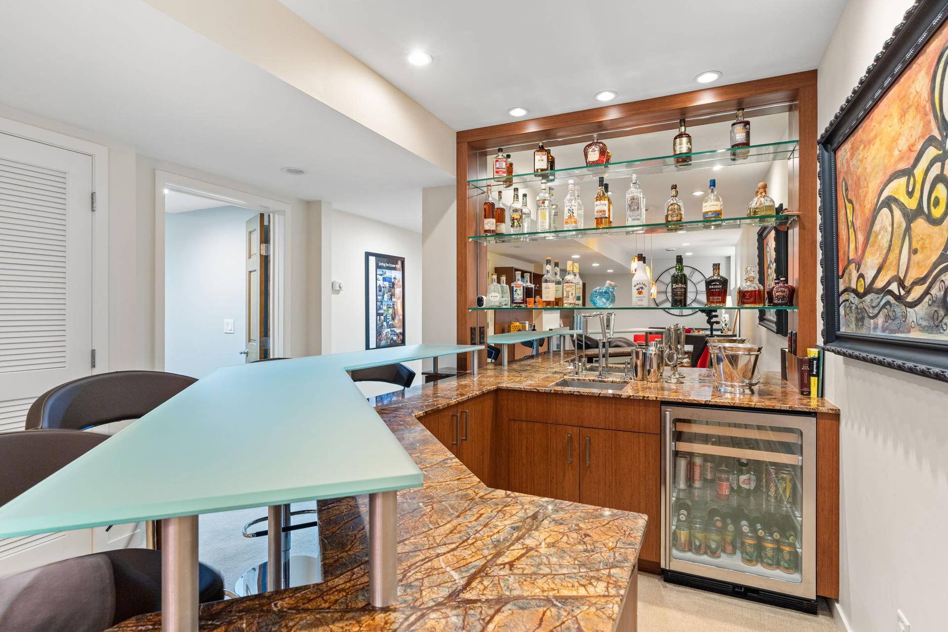 15393 Shadow Creek Road, Maple Grove, MN 55311 Stylish wet bar complete with a two-tier peninsula with glass countertop.