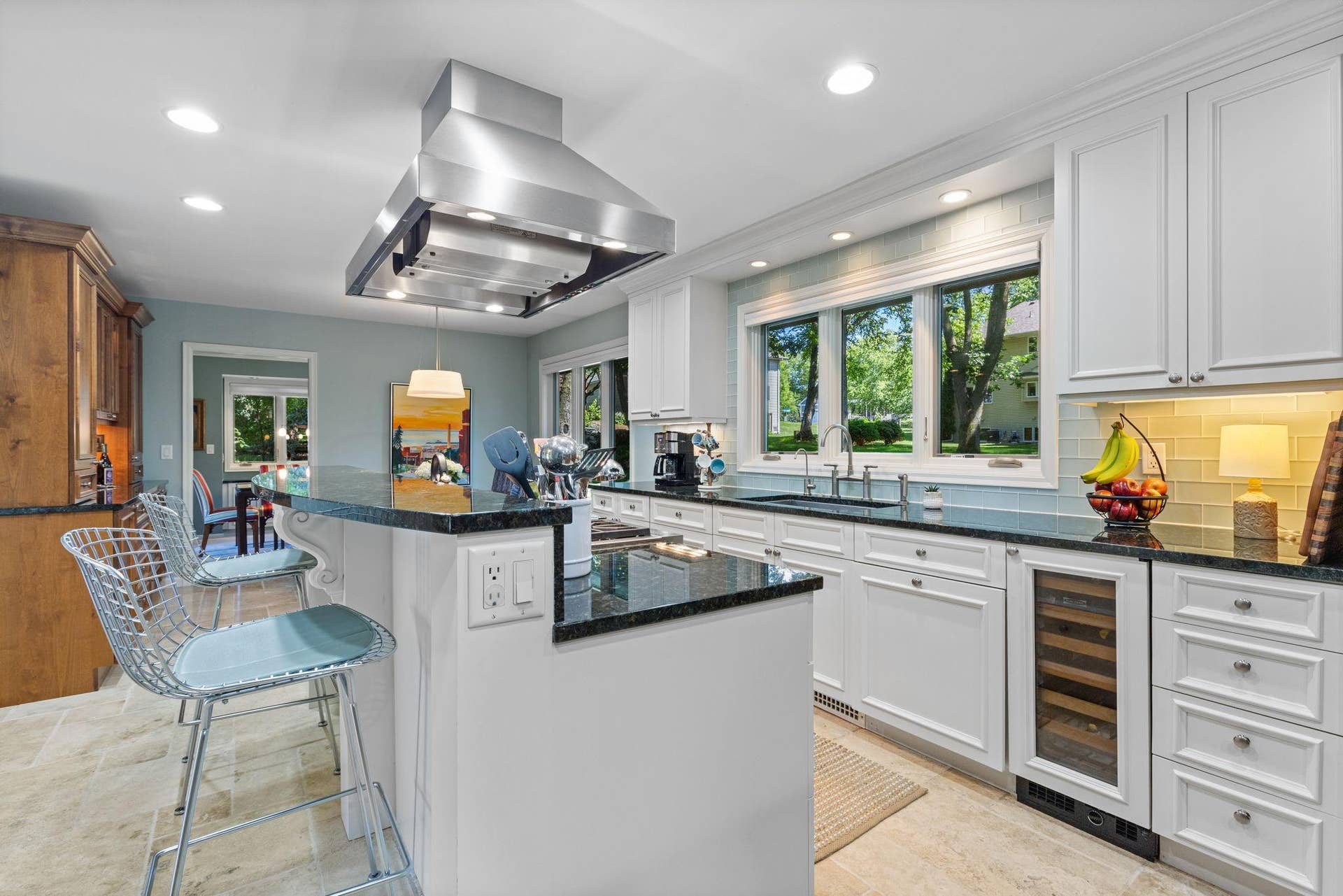15393 Shadow Creek Road, Maple Grove, MN 55311 Under-cabinet lighting, tile backsplash, and an oversized two-tier island with seating.