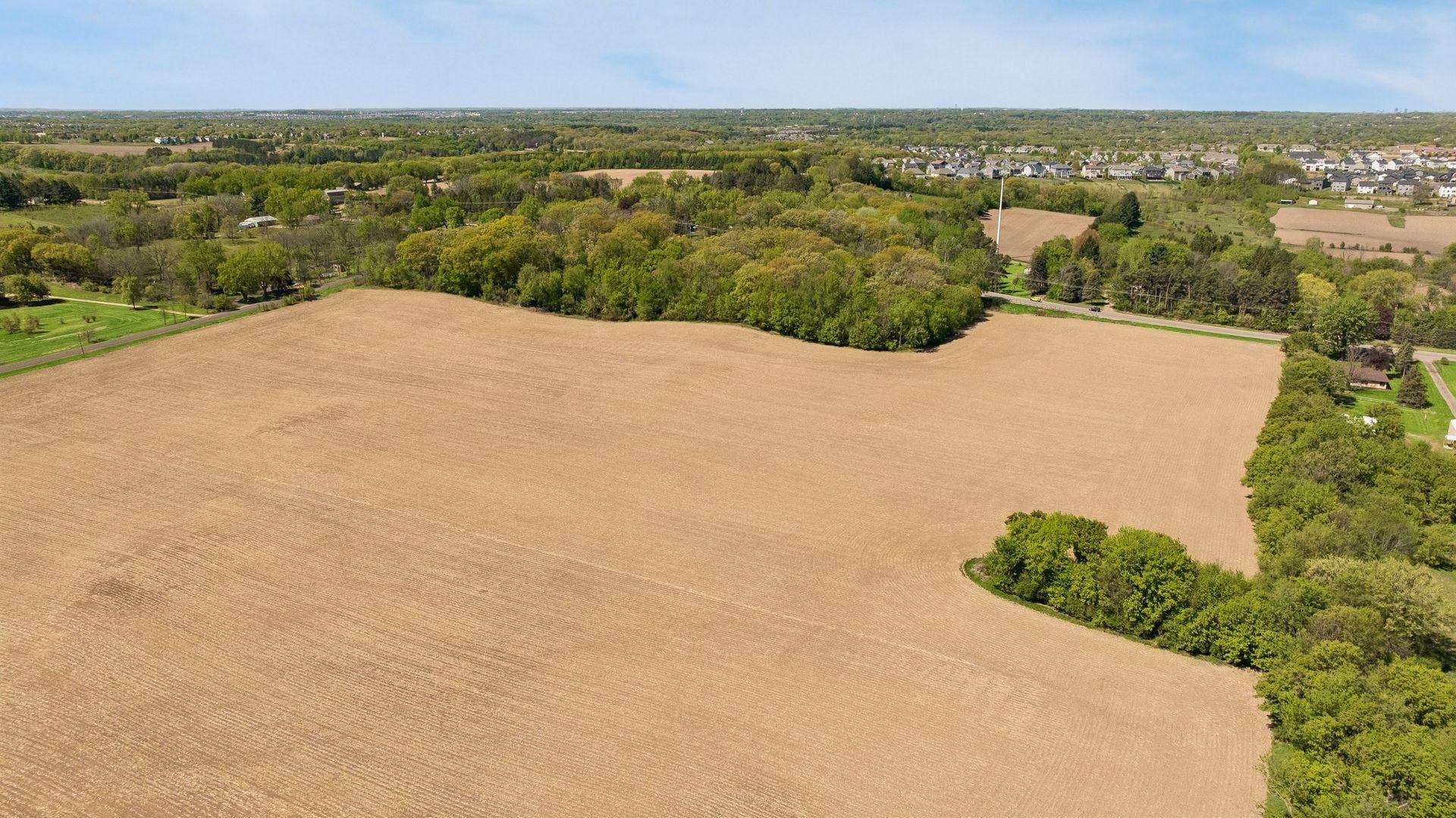 12150 S 15th Street, Afton, MN 55001 Gently rolling terrain unfolds into a picturesque landscape framed by mature trees, open meadows, and serene natural beauty in every direction.
