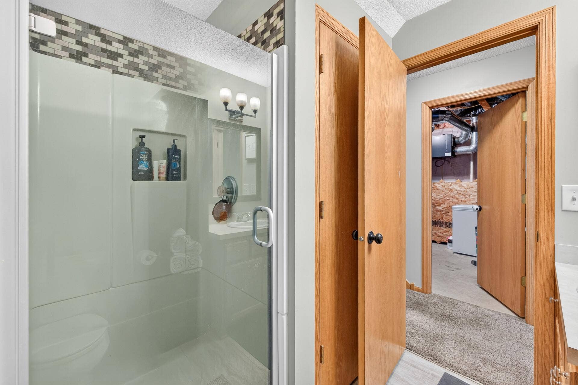 3765 Woodside Drive, Monticello, MN 55362 Lower-level full bath featuring a walk-in shower and convenient access to the potential primary suite.