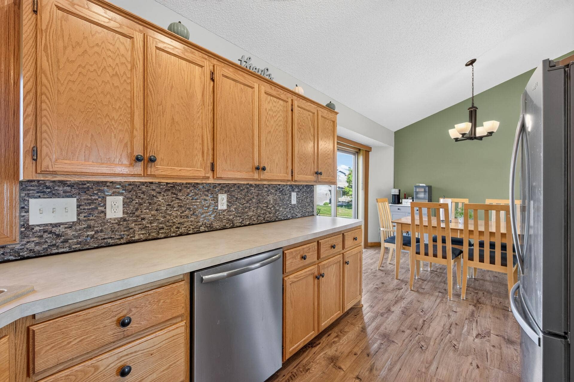 3765 Woodside Drive, Monticello, MN 55362 Generous kitchen cabinetry and counter space flow seamlessly into the bright dining area.