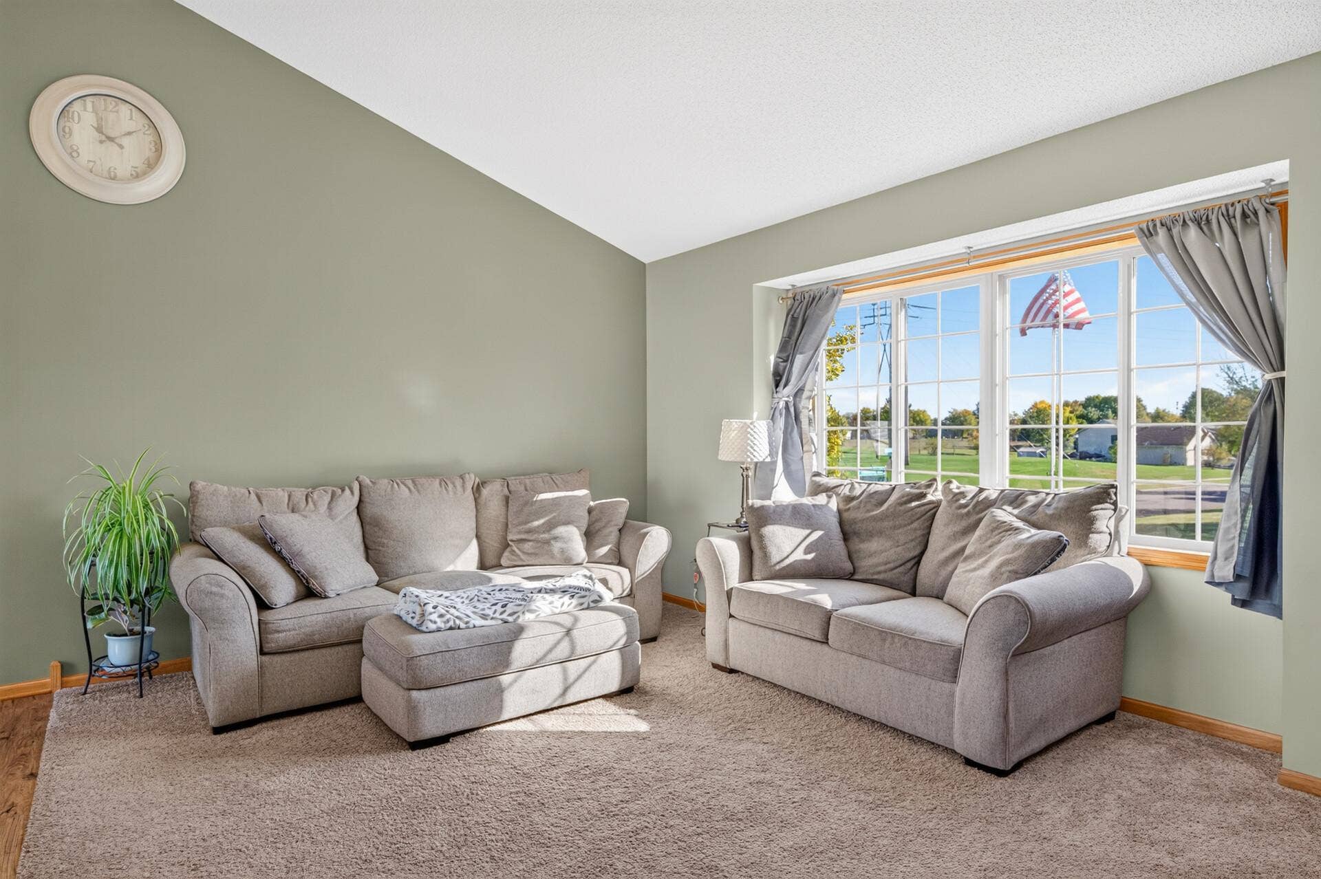3765 Woodside Drive, Monticello, MN 55362 Inviting living room with vaulted ceiling, plush carpeting, and an oversized picture window filling the space with natural light.