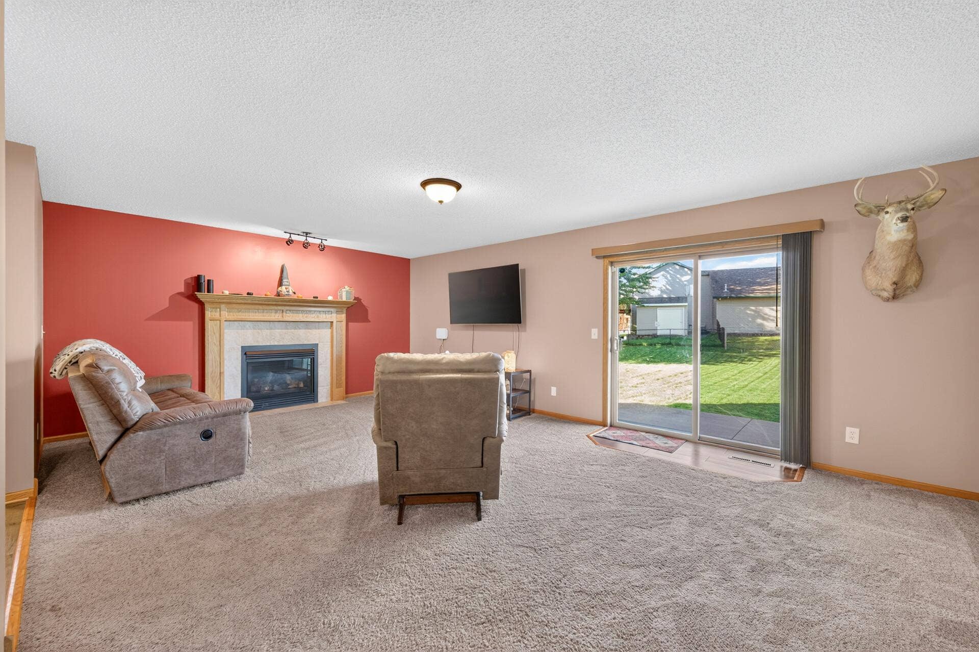 3765 Woodside Drive, Monticello, MN 55362 Spacious main-level family room featuring a cozy gas fireplace and sliding glass door with easy access to the backyard.