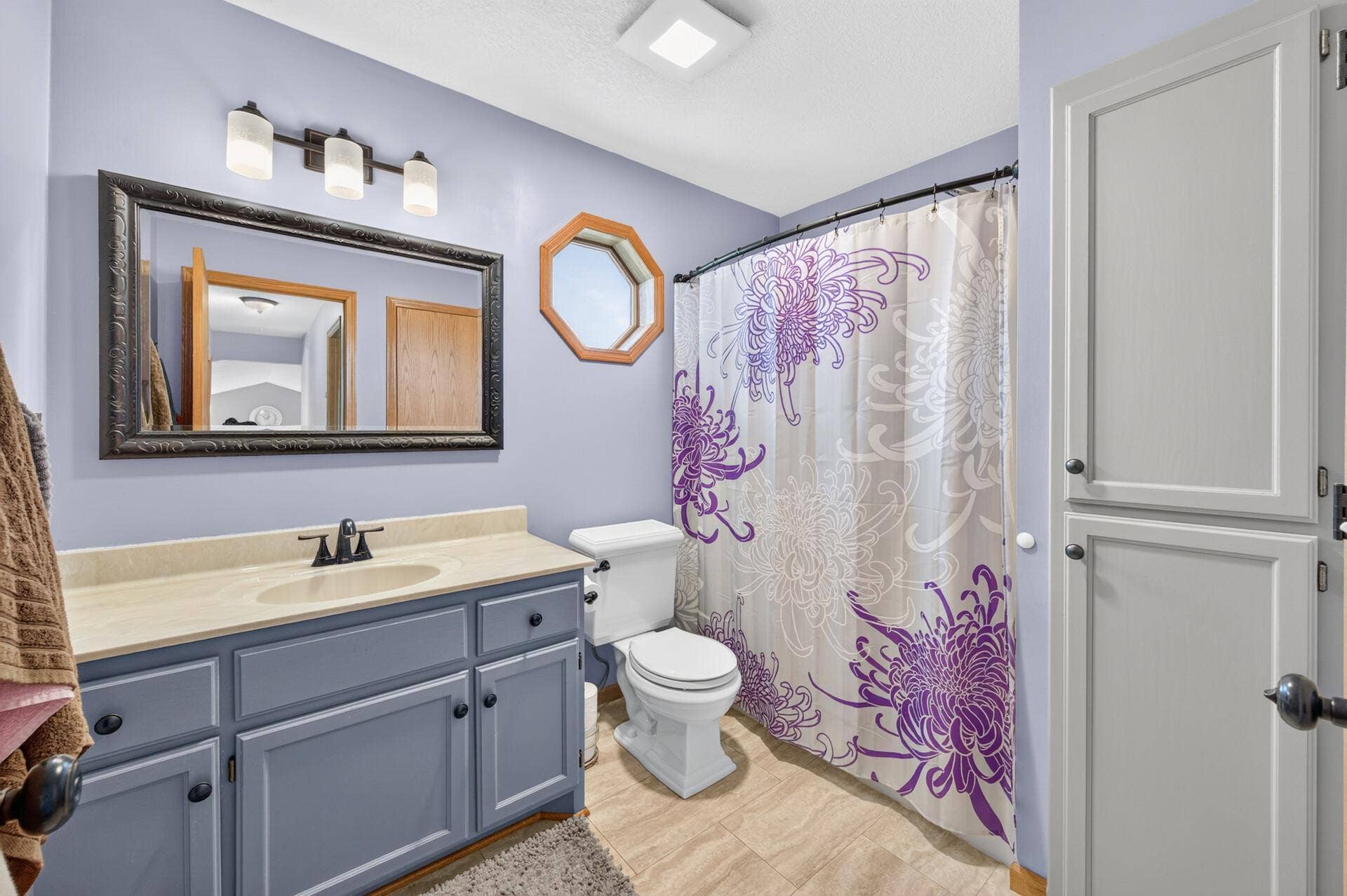 3765 Woodside Drive, Monticello, MN 55362 Upper-level full bath featuring ample vanity storage, updated fixtures, and additional built-in storage.