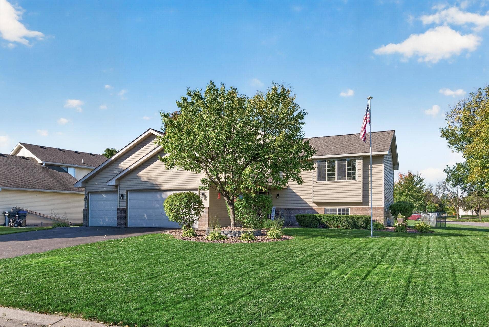 3765 Woodside Drive, Monticello, MN 55362 Impressive curb appeal with a beautifully manicured lawn, mature landscaping, and spacious three-car garage.