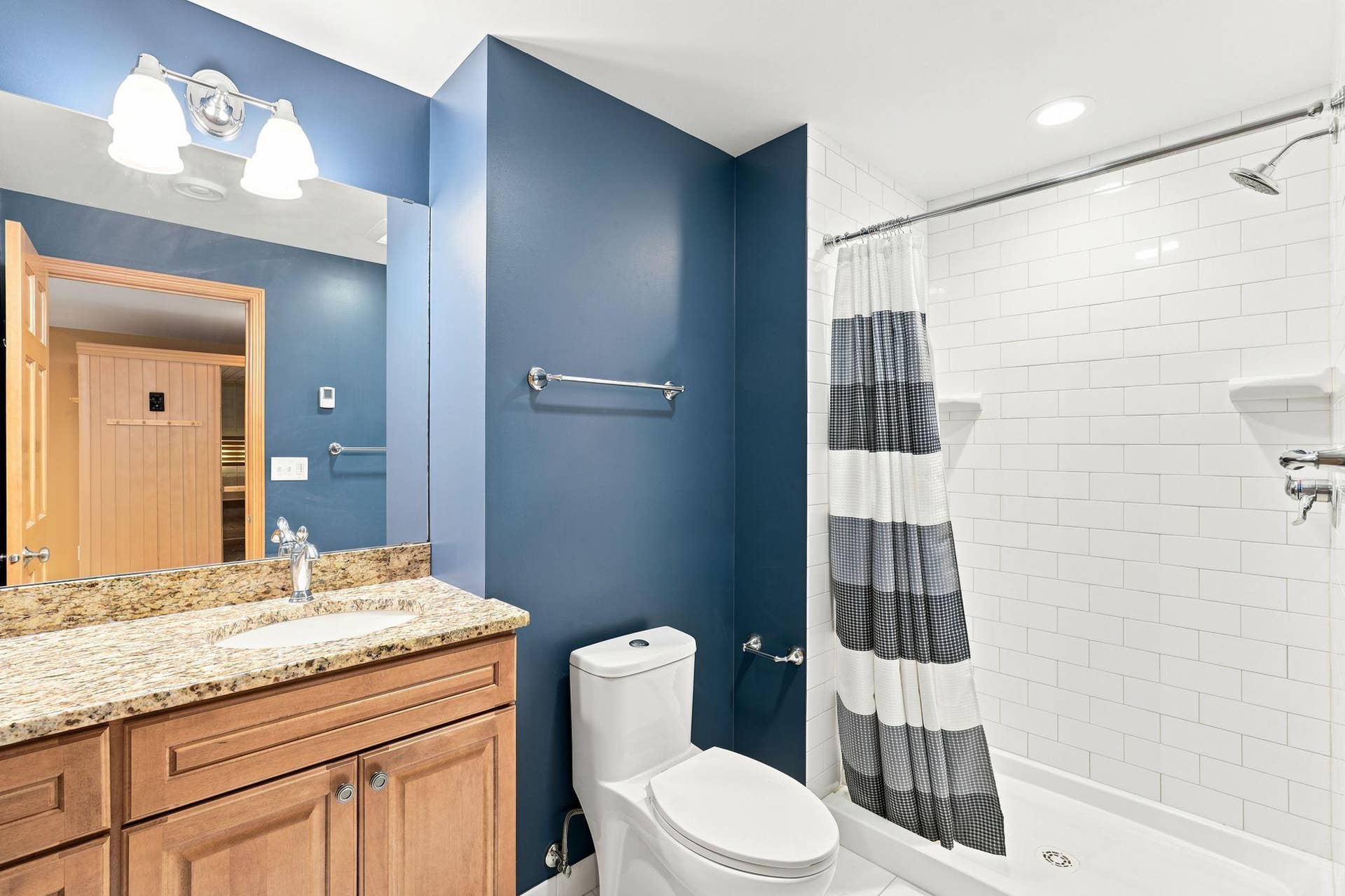 7143 Arthur Drive, Woodbury, MN 55125 Beautiful three-quarter lower level bathroom with heated flooring, quartz counter, and tiled shower.