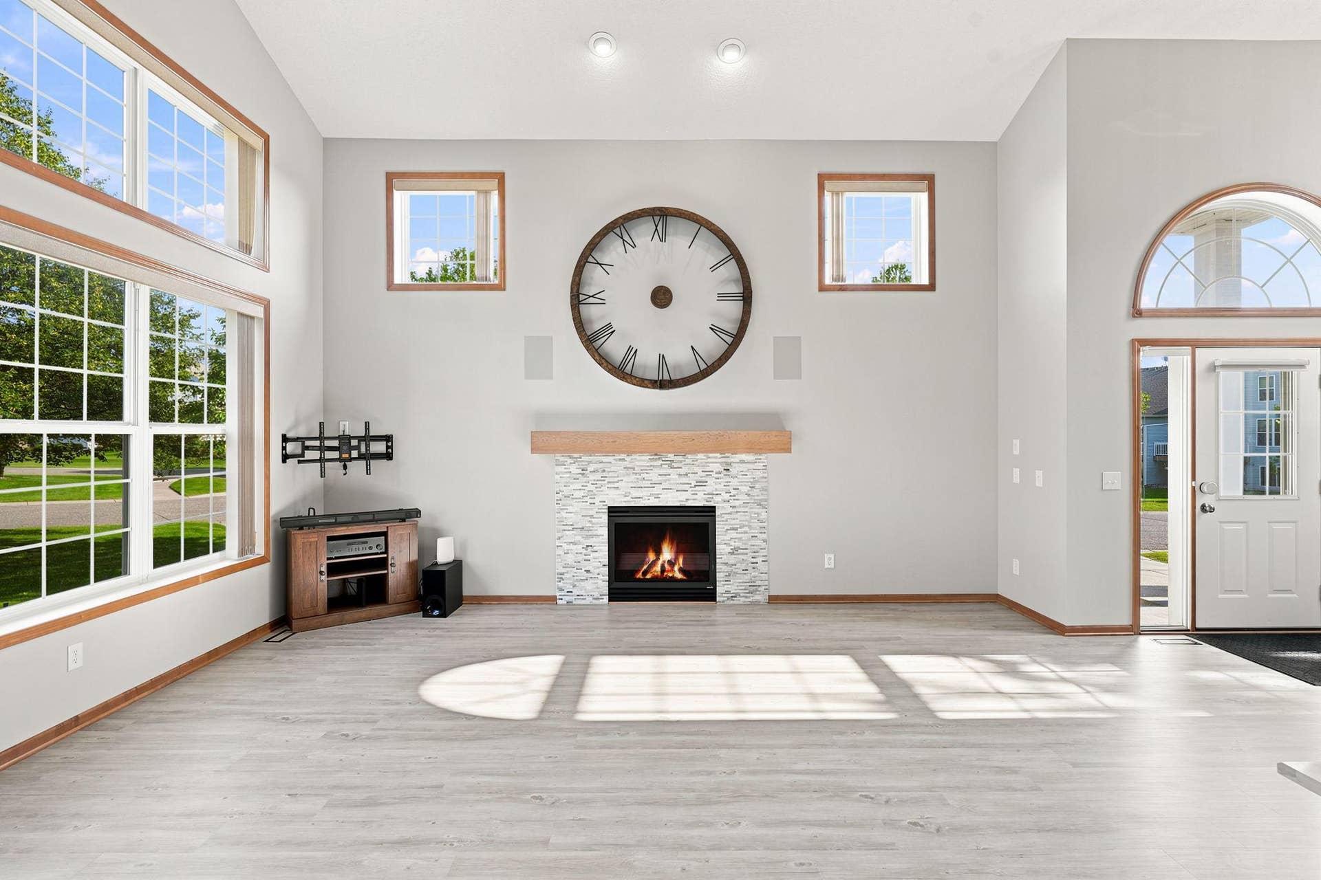 7143 Arthur Drive, Woodbury, MN 55125 Newly installed custom fireplace with hand-made white oak mantle. Integrated audio system is synchronized between living room and primary suite.
