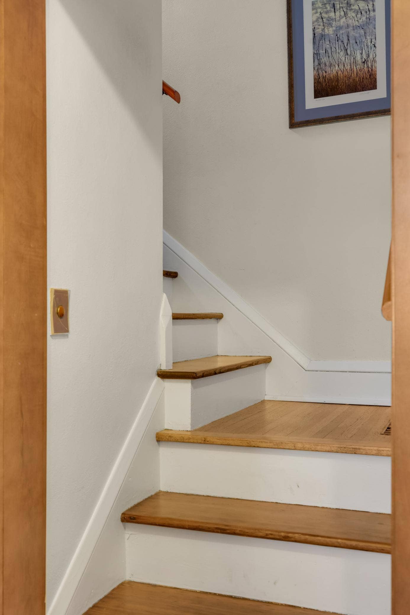 The beautifully detailed staircase leads up to the upper level