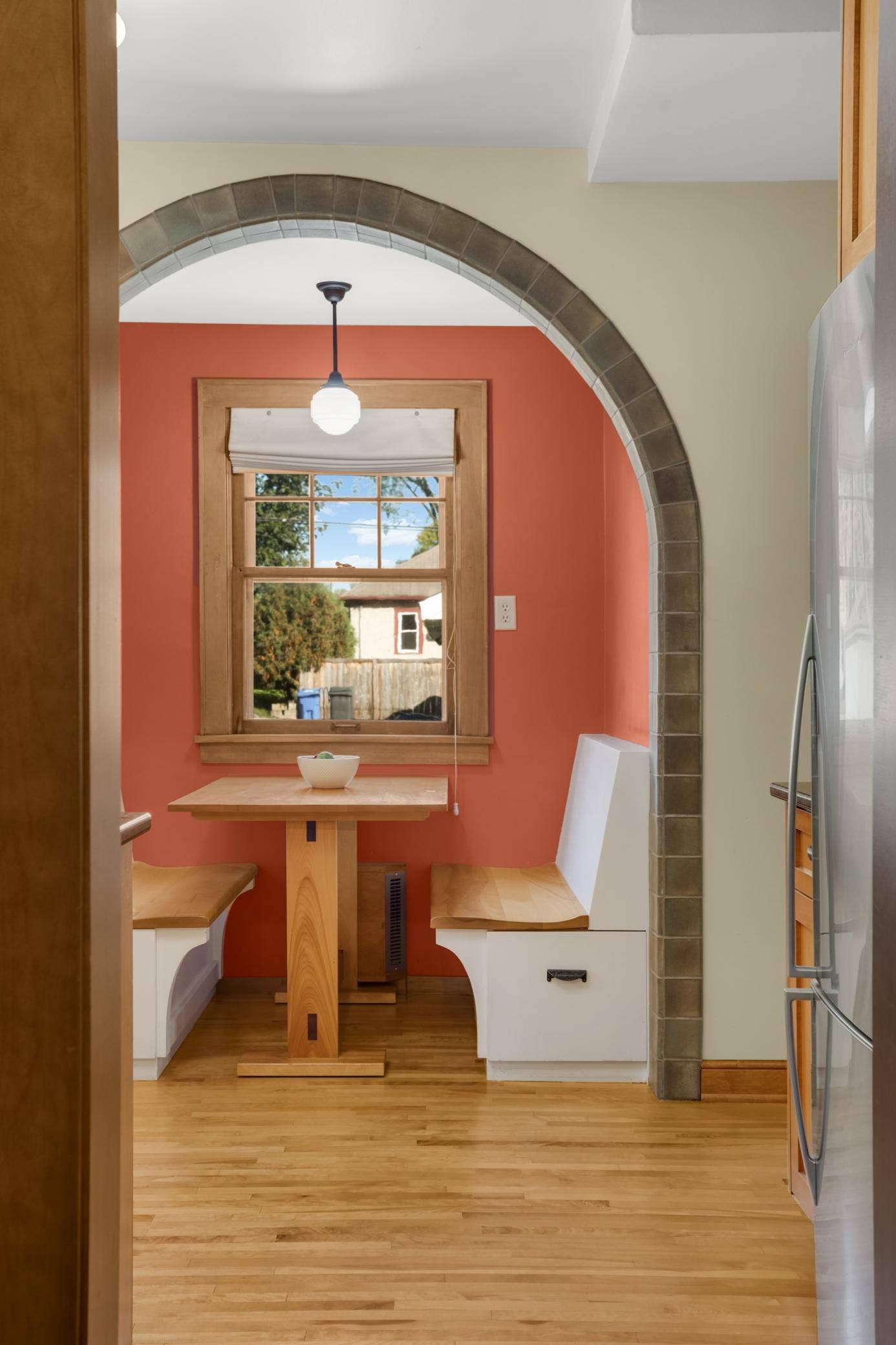 The built-in seating in the breakfast nook features convenient drawers for added storage space