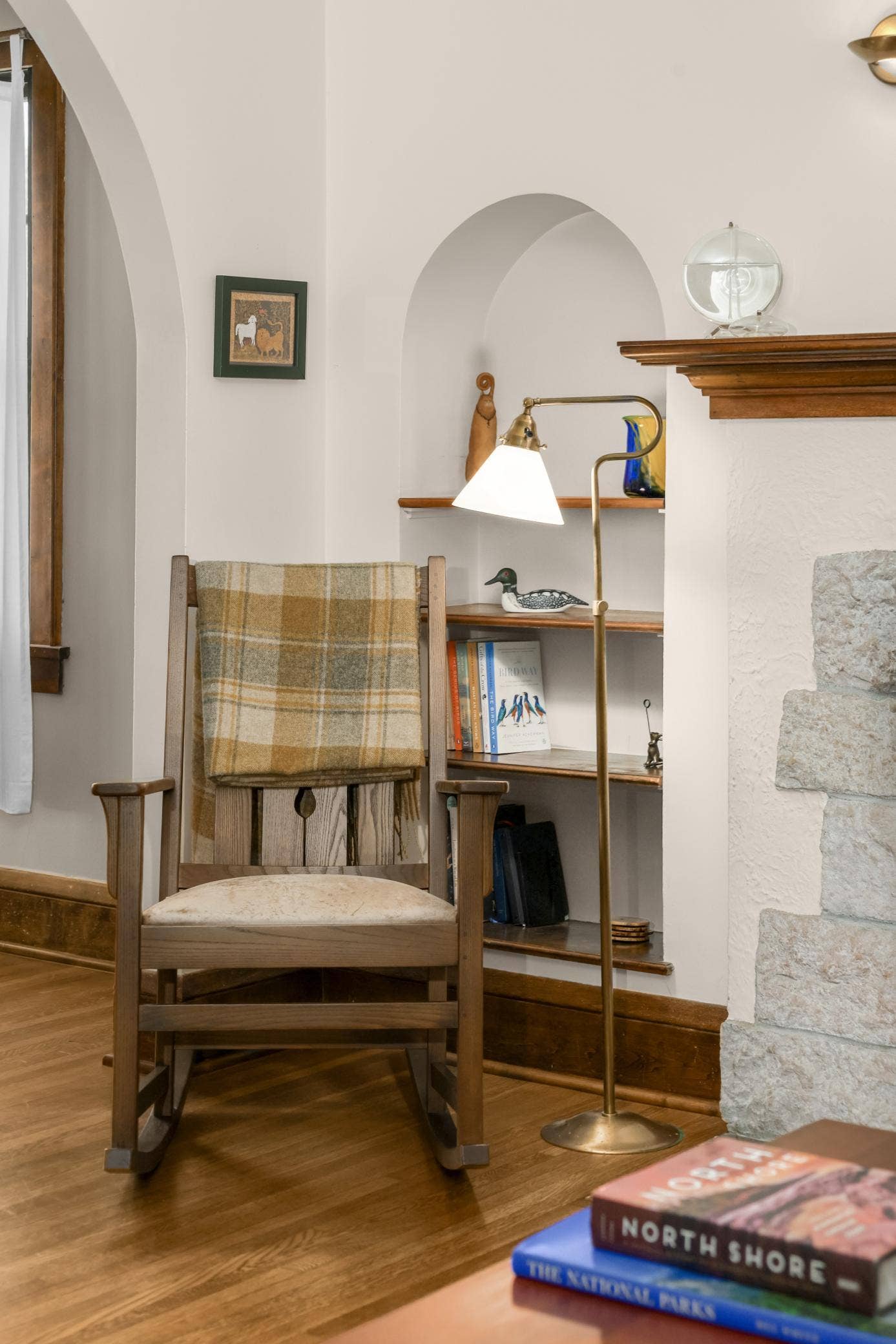 The arched built-in bookshelves frame the fireplace and add interesting detail to the space