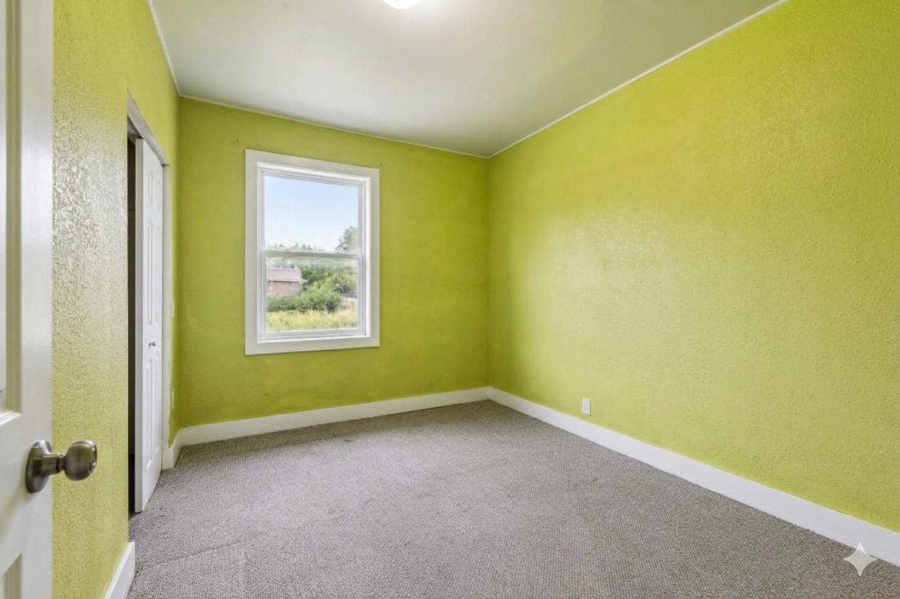 2533 Polk Street NE, 2, Minneapolis, MN 55418 Unit 2: A bright and comfortable main-floor bedroom with carpet, overhead light, and a double closet for extra storage.