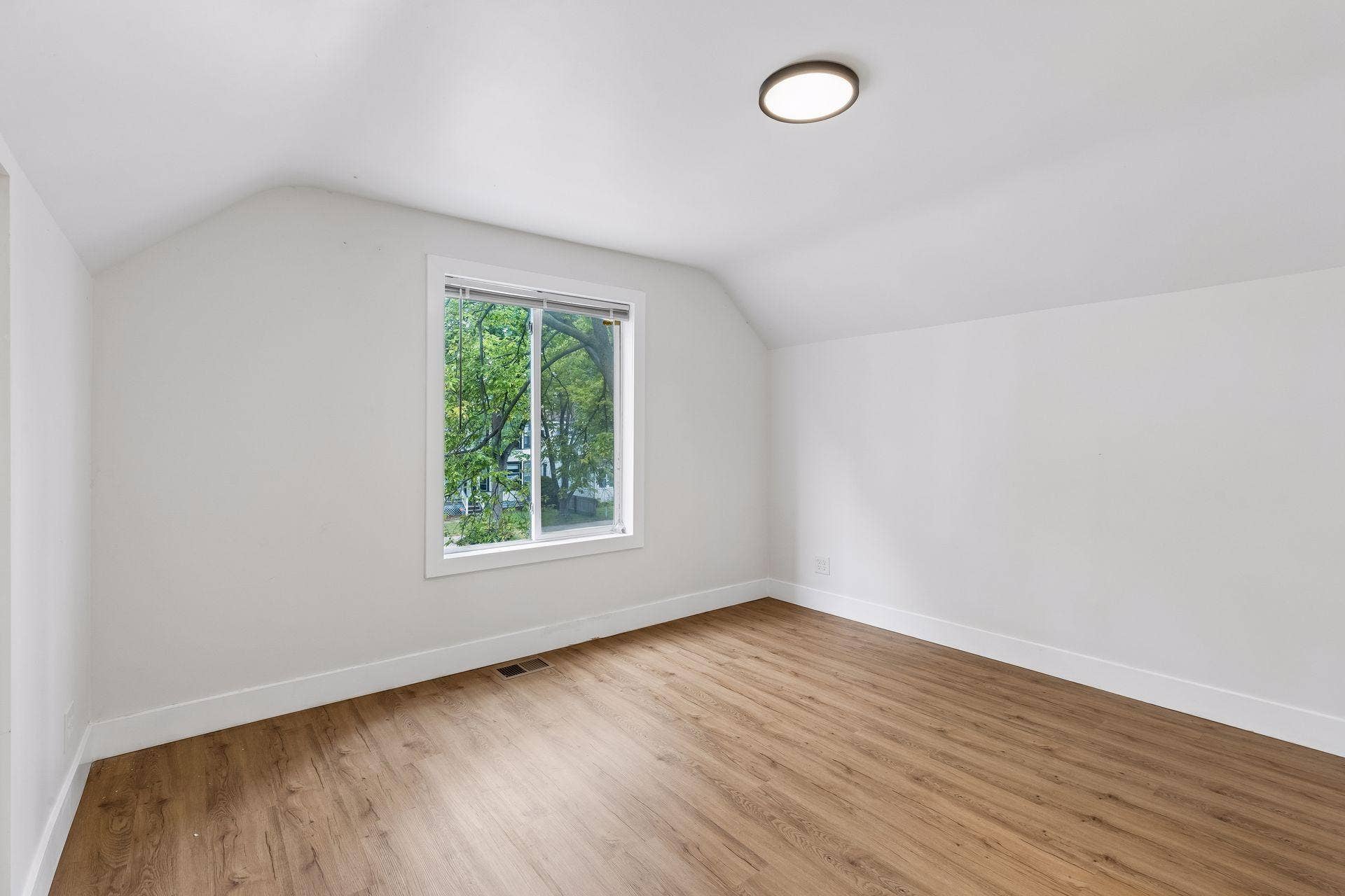2533 Polk Street NE, 2, Minneapolis, MN 55418 Unit 1: Two more bedrooms await upstairs! This first bedroom offers updated flooring, overhead lighting, and plenty of natural light.