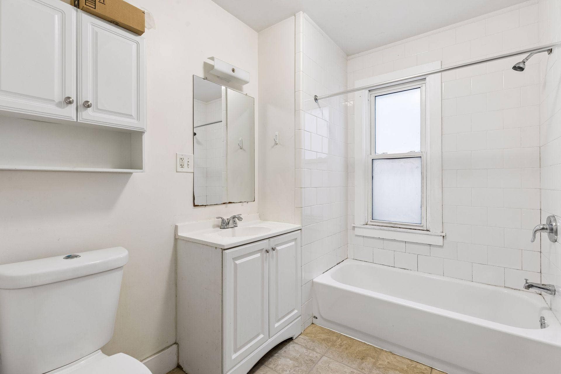 2533 Polk Street NE, 2, Minneapolis, MN 55418 Unit 2: This main floor full bath features a tub/shower combo, window, vanity, and cabinet storage for added functionality.