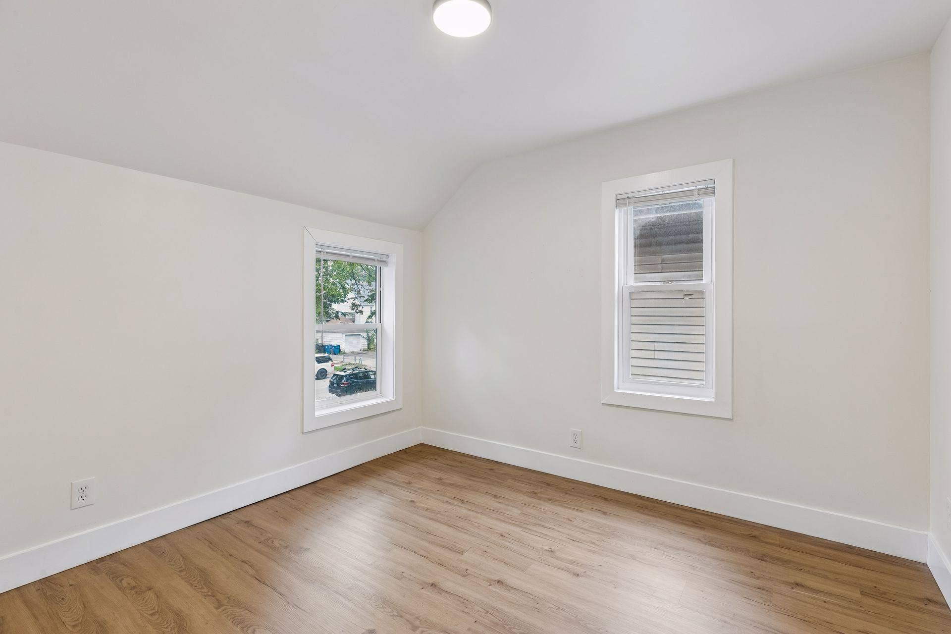 2533 Polk Street NE, 2, Minneapolis, MN 55418 Unit 1: The second upper-level bedroom offers two windows for natural light, updated flooring, and overhead lighting.