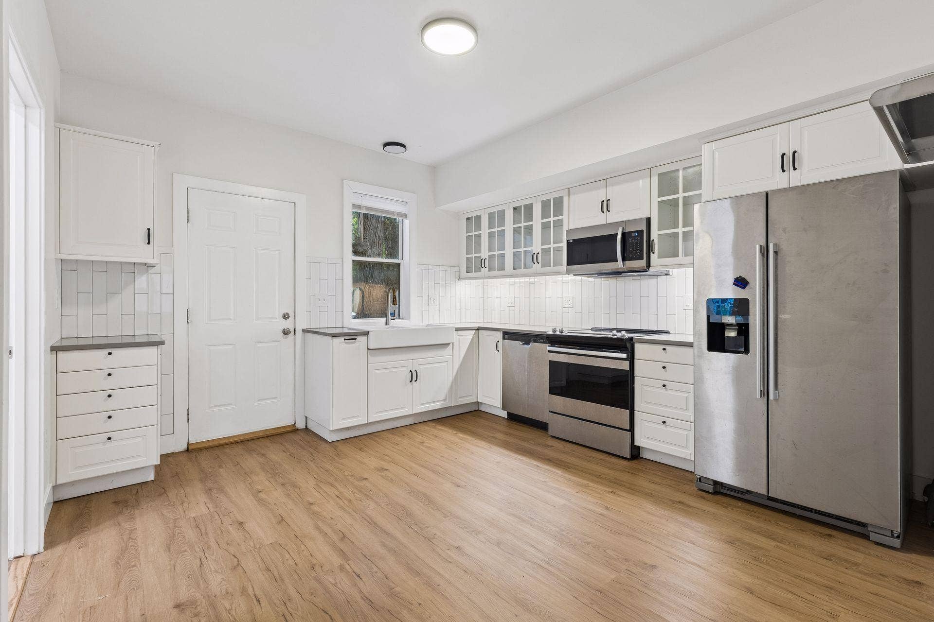 2533 Polk Street NE, 2, Minneapolis, MN 55418 Unit 1: Updated flooring, stainless steel appliances, overhead lighting, and abundant cabinet and counter space make this kitchen both stylish and functional.