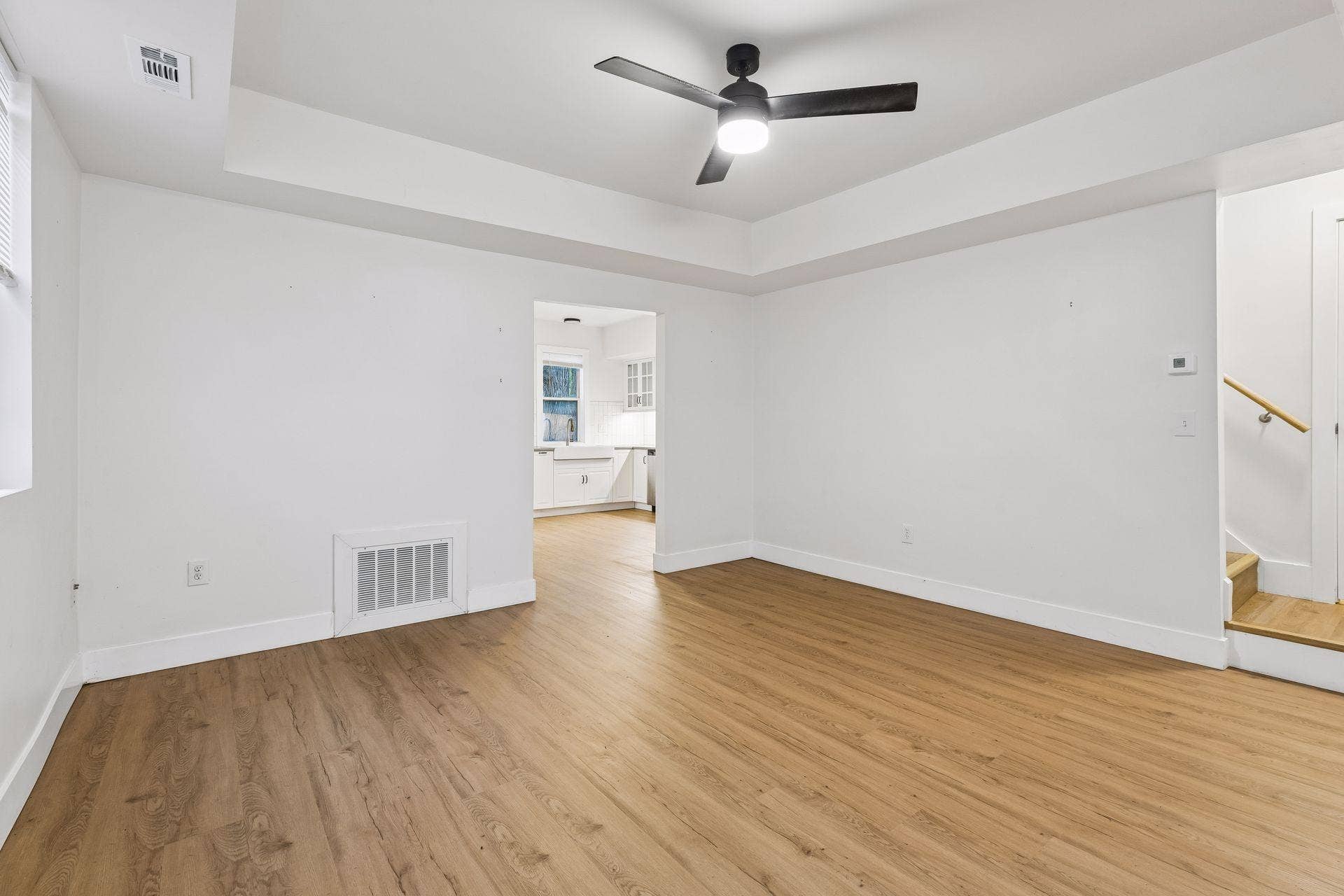 2533 Polk Street NE, 2, Minneapolis, MN 55418 Unit 1: Spacious living room featuring ceiling fan with light, updated flooring and windows for great natural light.