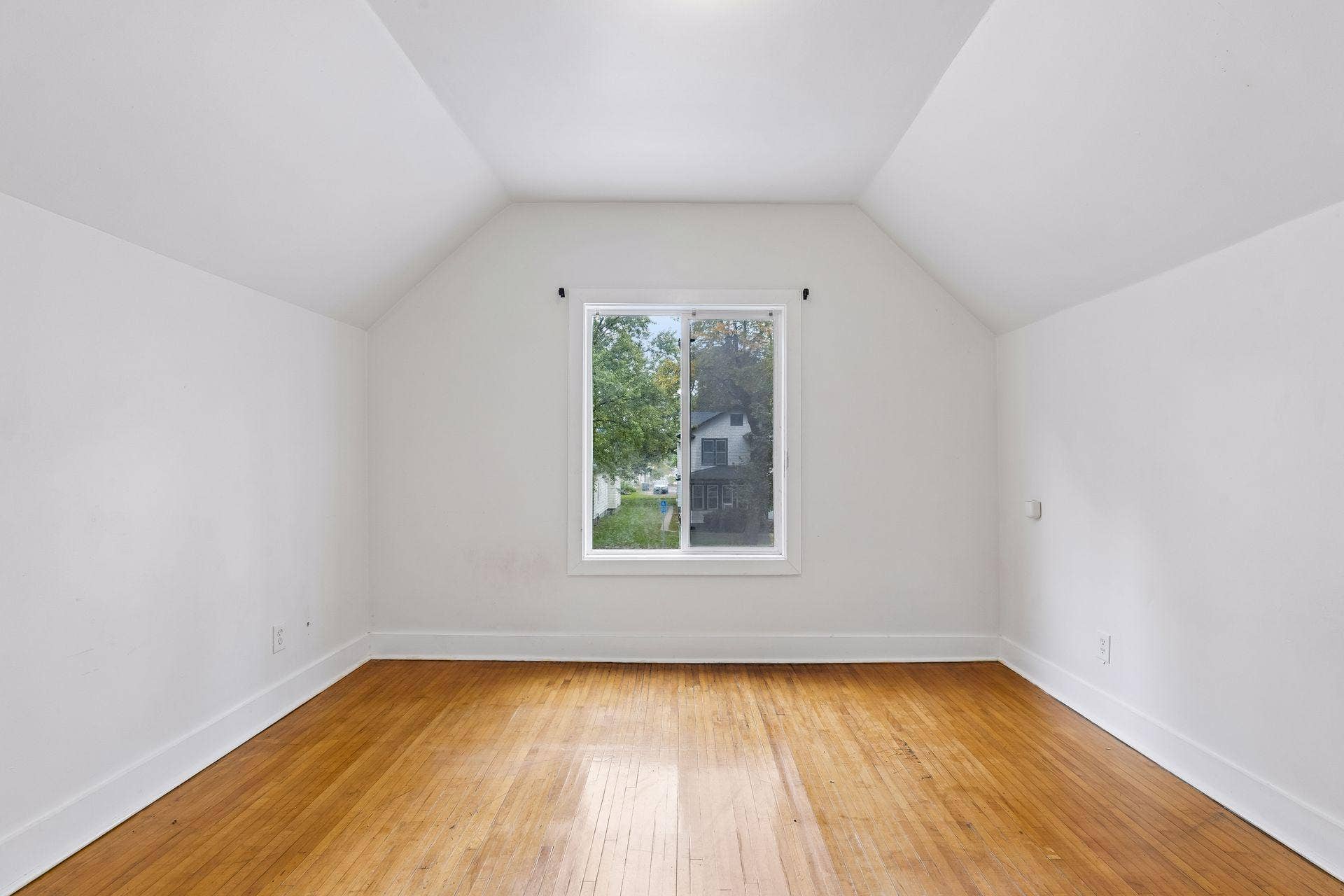 2533 Polk Street NE, 2, Minneapolis, MN 55418 Unit 2: Natural light fills this first of 2 upper-level bedrooms through a bright window, complemented by hardwood flooring and overhead lighting.