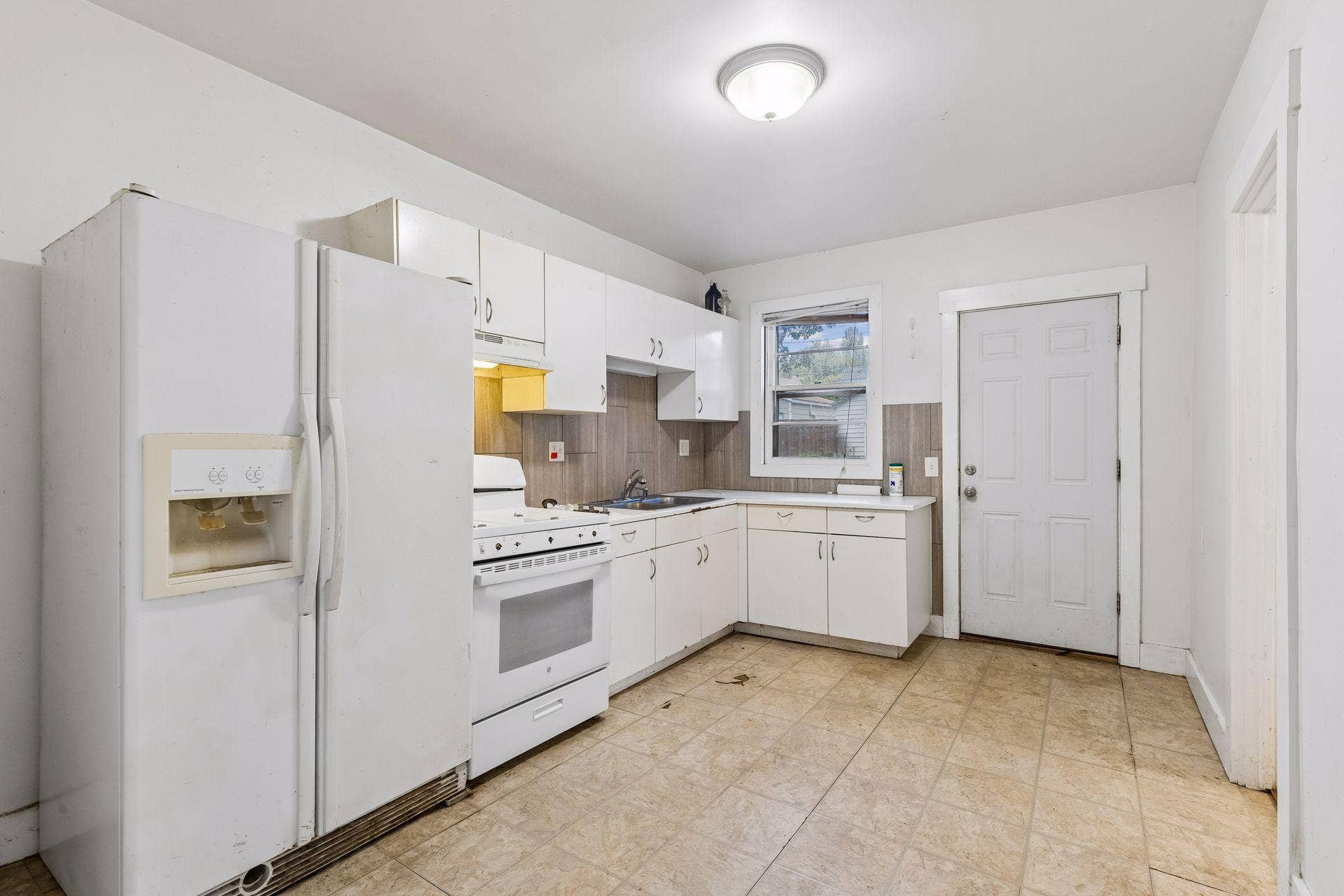 2533 Polk Street NE, 2, Minneapolis, MN 55418 Unit 2: The kitchen features a practical layout with ample cabinet and counter space, providing a great opportunity for future improvements.