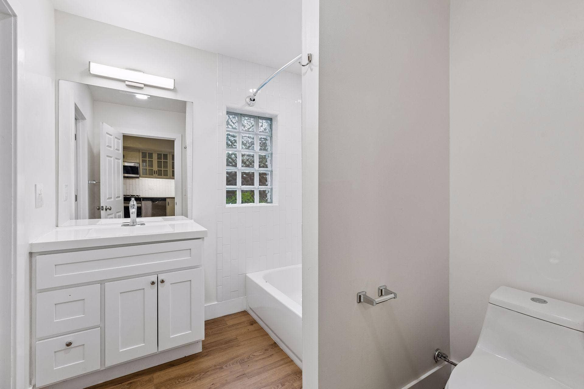 2533 Polk Street NE, 2, Minneapolis, MN 55418 Unit 1: Updated flooring, a vanity sink, overhead lighting, and tub/shower combo come together in this clean and functional full bath.