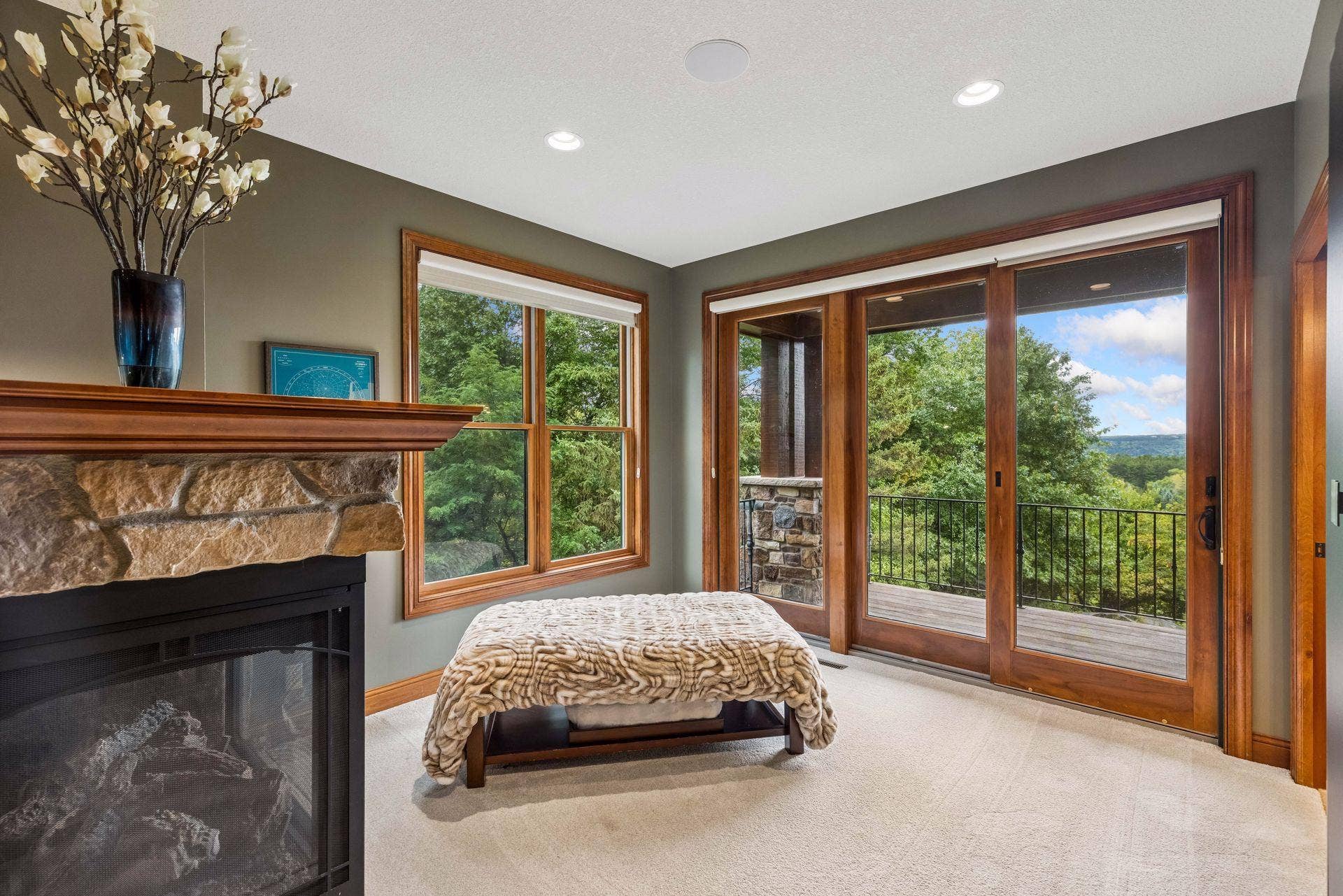 Sliding doors in the sitting area open to a private deck with treetop and valley views